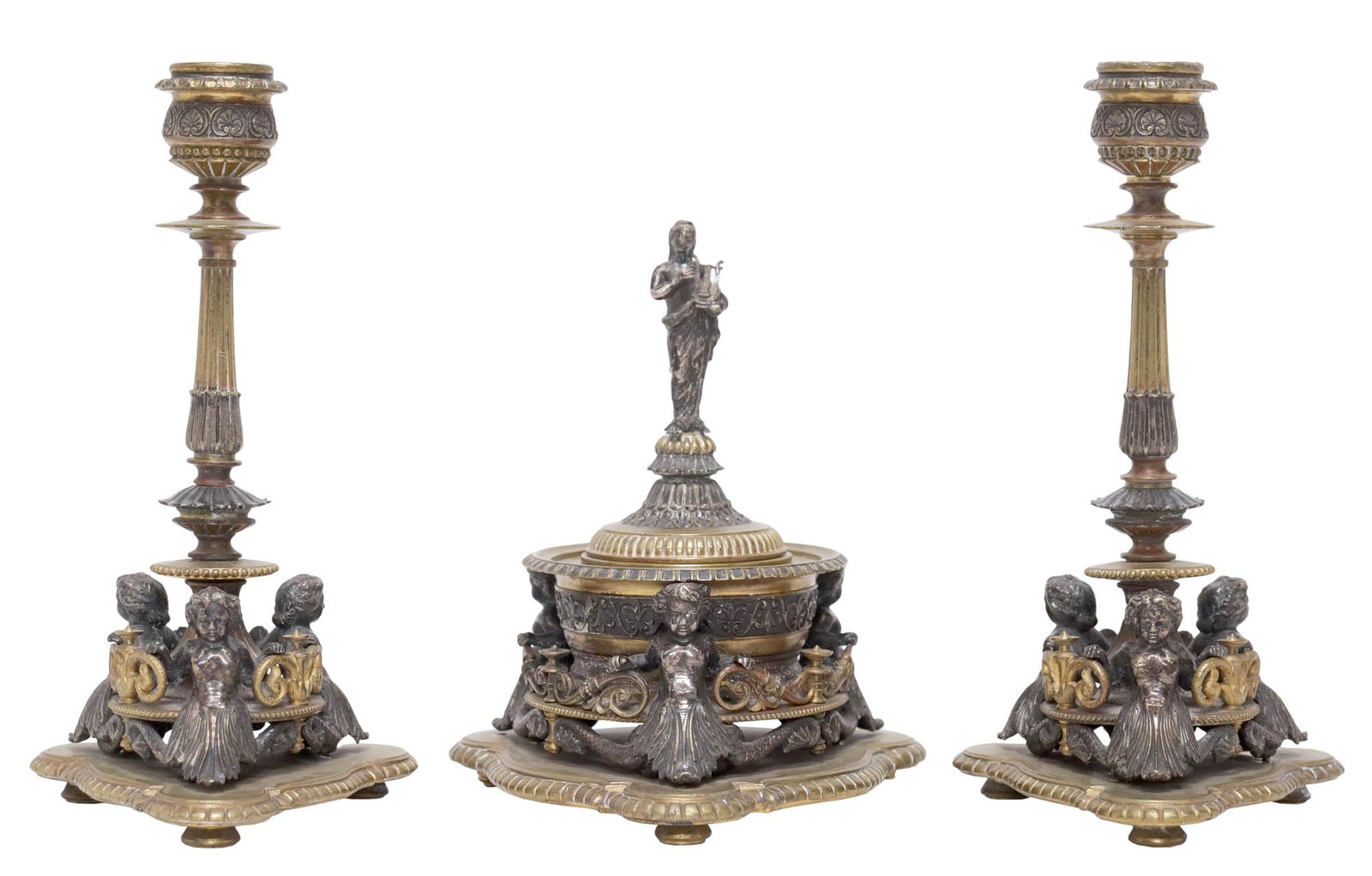 (3) NEOCLASSICAL STYLE BRONZE PUTTI DESK SET, INKWELL & CANDLESTICKS: (lot of 3) Neoclassical style patinated and gilt-bronze desk set, late 19th c., each having tripartite base with protruding serpentine cherubs, pierced foliate scrollwork and gadrooned accents, on