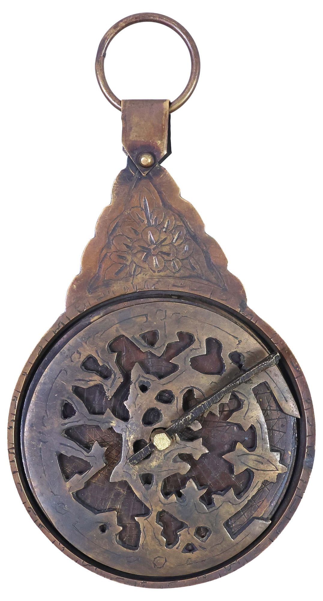 ISLAMIC PATINATED & ENGRAVED BRASS ASTROLABE INSTRUMENT: Islamic patinated brass astrolabe, having an engraved floral medallion and ring handle, above delineated mater, framing openwork rete stacked atop rotating celestial sphere, four quadrants with