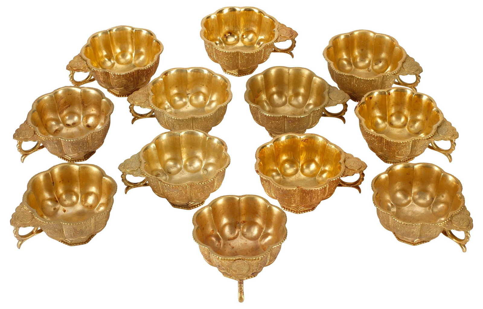 (12) CHINESE GILT BRONZE FIGURAL-DECORATED LOBED CUPS: (lot of 12) Chinese gilt bronze cups, each of lobed form, with alternating figural scenes and foliate motifs, apocryphal four-character mark underfoot, approx 2"h, 4"w, 3.5"d, 6lbs total