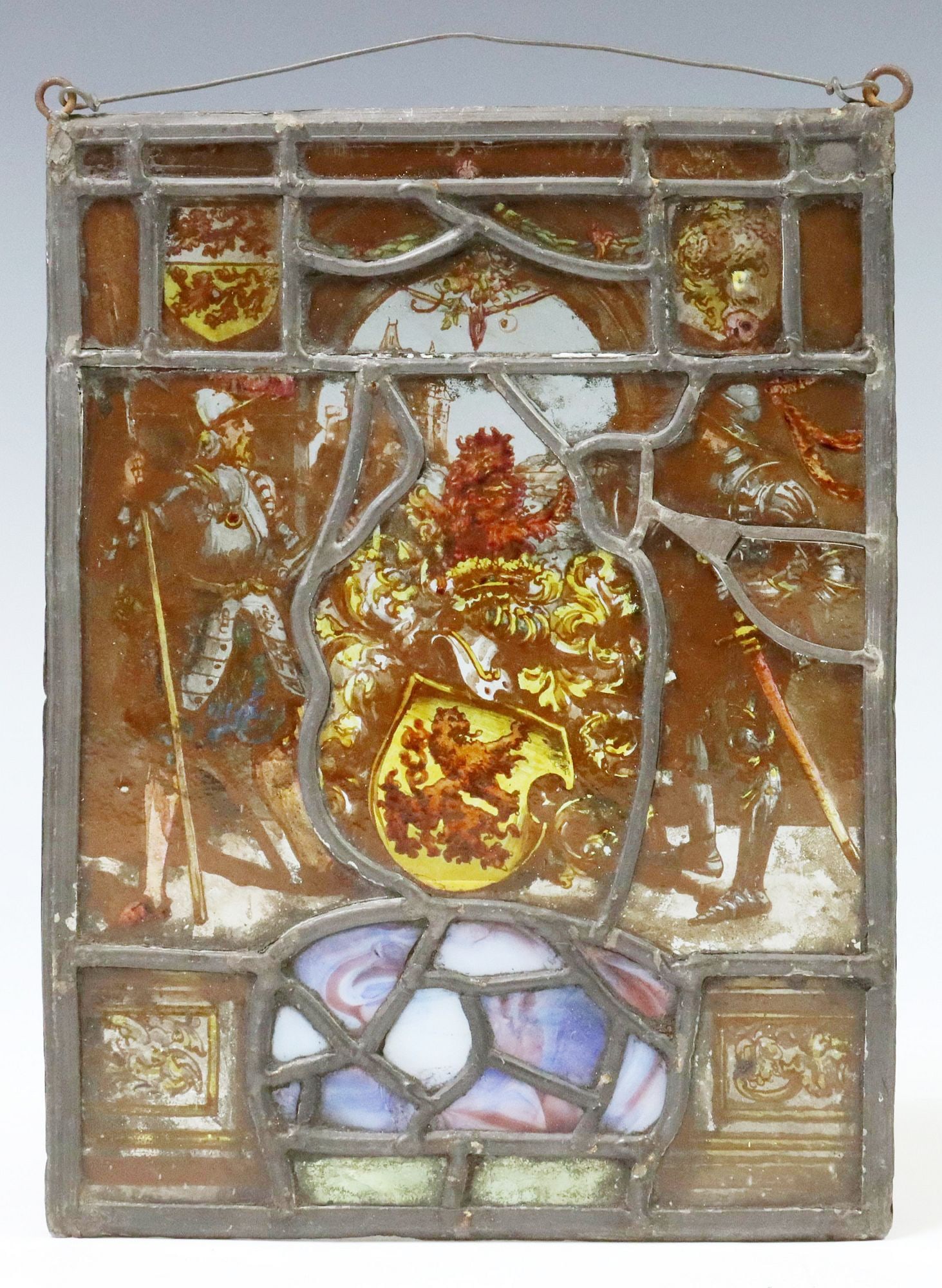 STAINED & REVERSE-PAINTED GLASS ARMORIAL PANEL: Stained and leaded glass armorial/ hanging plaque, rectangular frame, with inset stained and reverse-painted glass panels, depicting two knights, standing among heraldic motifs, approx 11.5"h, 8.
