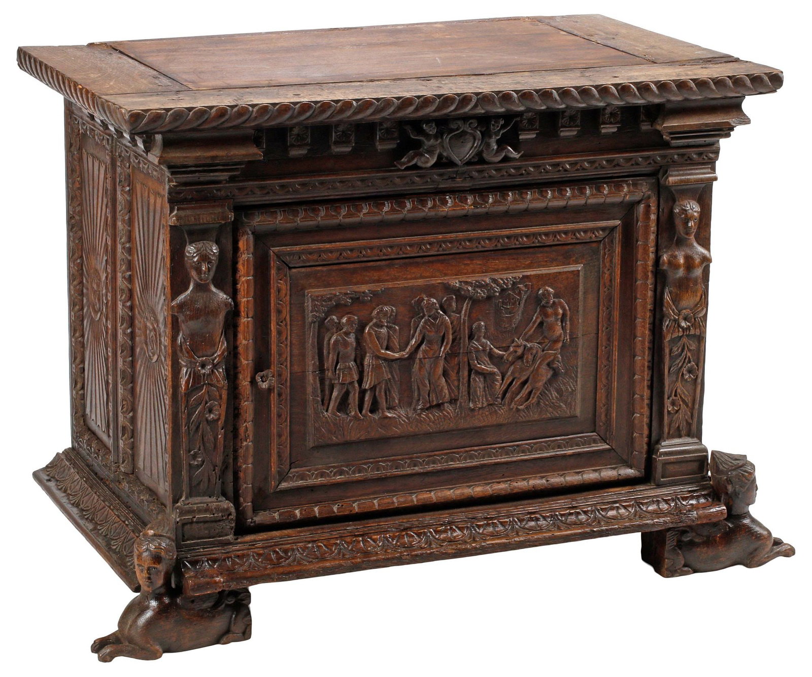 RENAISSANCE REVIVAL CARVED OAK LOW CABINET ON SPHINX FEET: Renaissance Revival carved oak low cabinet, 19th c., having gadrooned cornice, above single door with allegorical scene, revealing open interior, depicting figures and horses gathered in a grove,