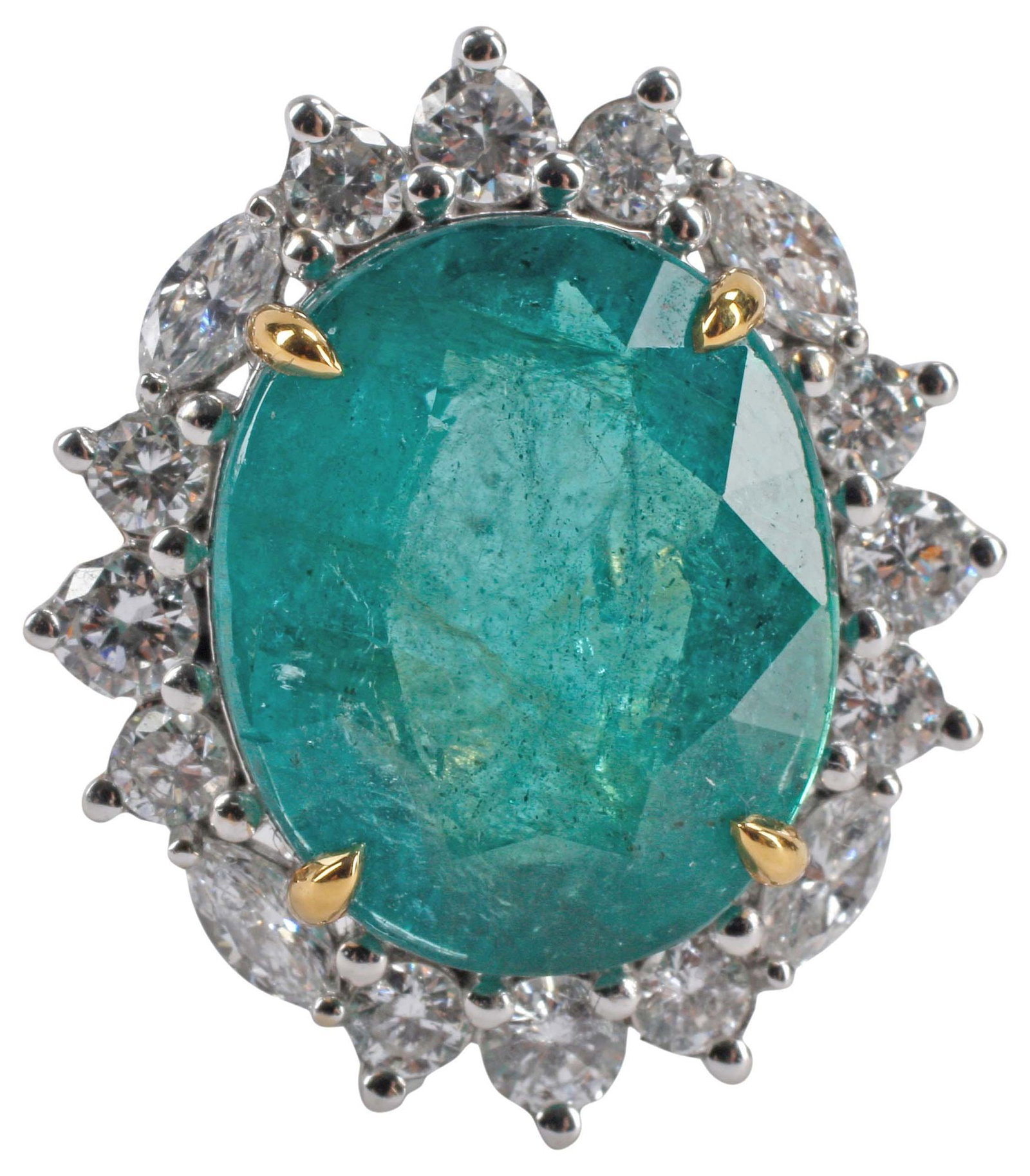 ESTATE 18KT TWO-TONE GOLD, 4.50CT EMERALD & DIAMOND HALO RING: Estate 18kt bicolor gold (tested) and gemstone halo ring, central white gold mount holding an oval-cut emerald, approx 4.50cts, in a surround of (sixteen) round and marquise-cut diamonds, approx