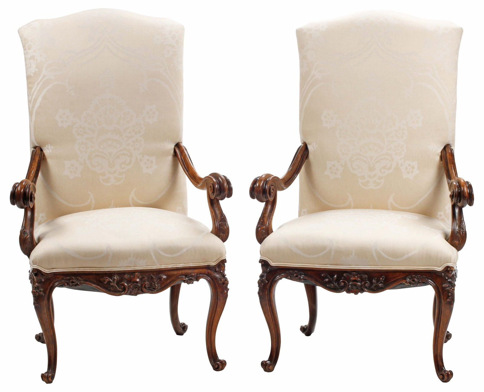 (2) LOUIS XV STYLE WALNUT & SILK-UPHOLSTERED HIGHBACK ARMCHAIRS / FAUTEUILS: (pair) Louis XV style walnut highback armchairs/ fauteuils, each in a cream silk-blend damask upholstery, curved arms with scrolled handholds, raised on foliate-carved cabriole legs, approx