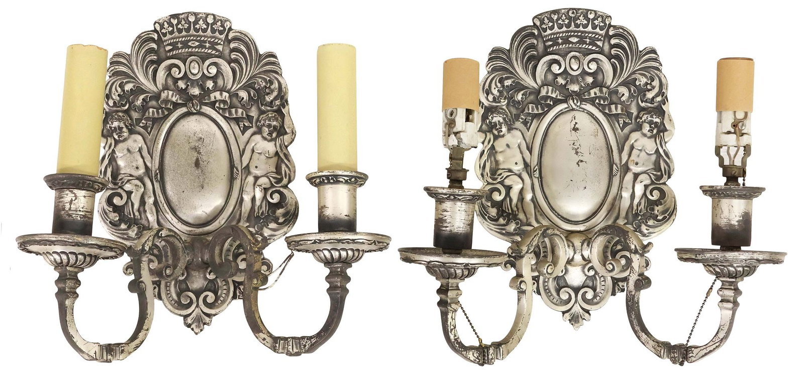 (2) STERLING BRONZE CO. SILVER GILT CHERUB 2-LIGHT WALL SCONCES: (pair) American silvered bronze two-light wall sconces, Sterling Bronze Company, New York, early 20th c., each with crown form crest, over central concave polished mirror, flanked by cherubs, having t