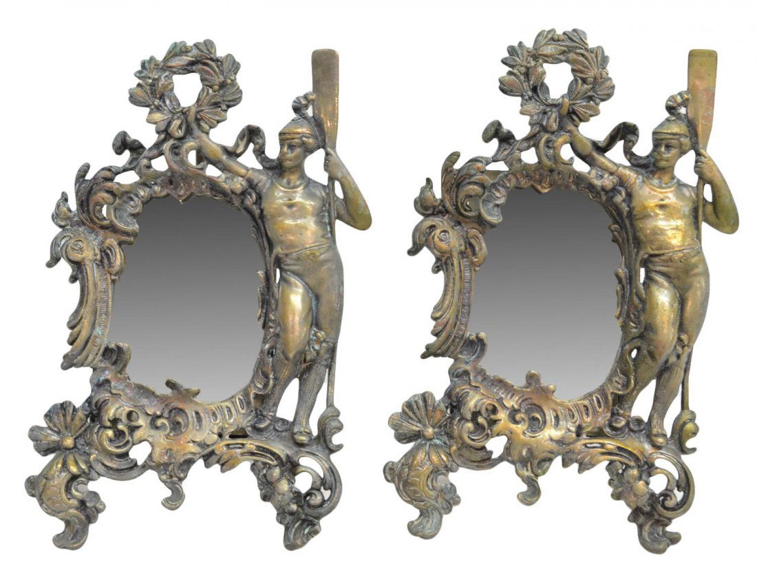 (PAIR) EARLY 20th C. GILT METAL FIGURAL MIRRORS: (pair) Continental gilt metal figural table mirrors, early 20th c.,a figure with oar standing aside the ornate frame with pierced foliate borders, 11.5"h, 7.5"w, 4.75lbs total Start Price: $200.00