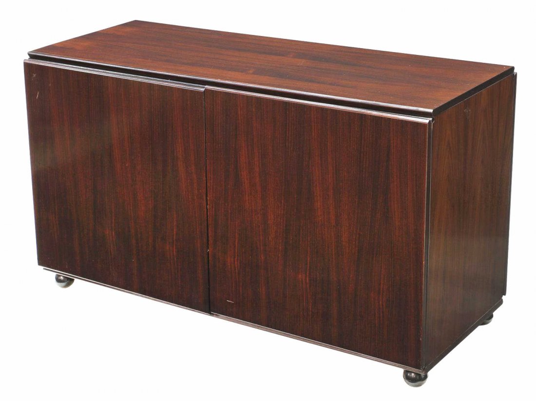 MID-CENTURY ROSEWOOD SIDEBOARD, CLAUDIO SALOCCHI: Italian mid-century modern rosewood sideboard, designed by Claudio Salocchi (Italian, b. 1943-) for Sormani, c. 1970, the case of diminutive form having two doors, interior shelves, finished all aroun