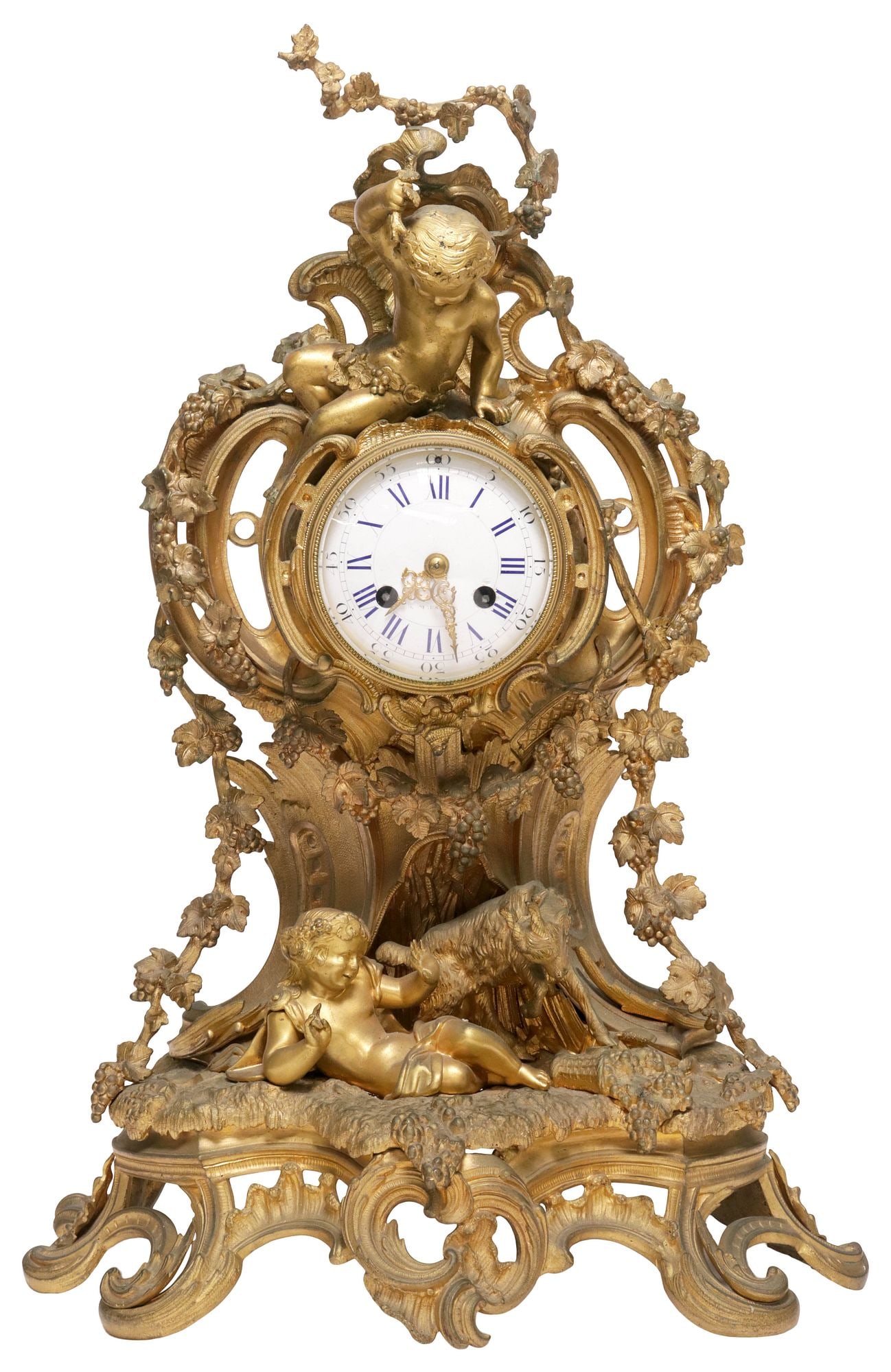 LARGE FRENCH LOUIS XV STYLE BACCHANALIAN PUTTI ORMOLU MANTEL CLOCK: Large French Louis XV style bronze dore mantel clock, late 19th c., scrolling foliate case surmounted by Bacchanalian putti and ram, among trailing grape vines, beveled glass door over white porcelain