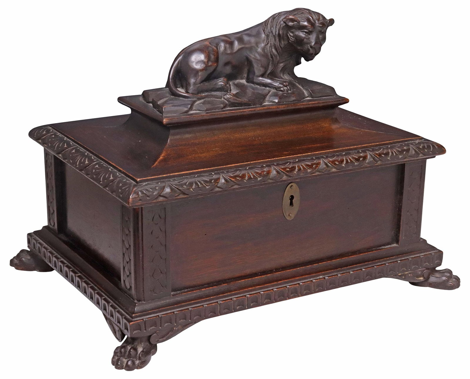 ITALIAN CARVED WALNUT RECUMBENT LION TABLE BOX / JEWELRY CASKET: Italian carved walnut table box or jewelry casket, 20th c., surmounted by a recumbent lion, rectangular case with hinged over, revealing mirrored and fabric-lined interior, rising on paw feet, approx 
