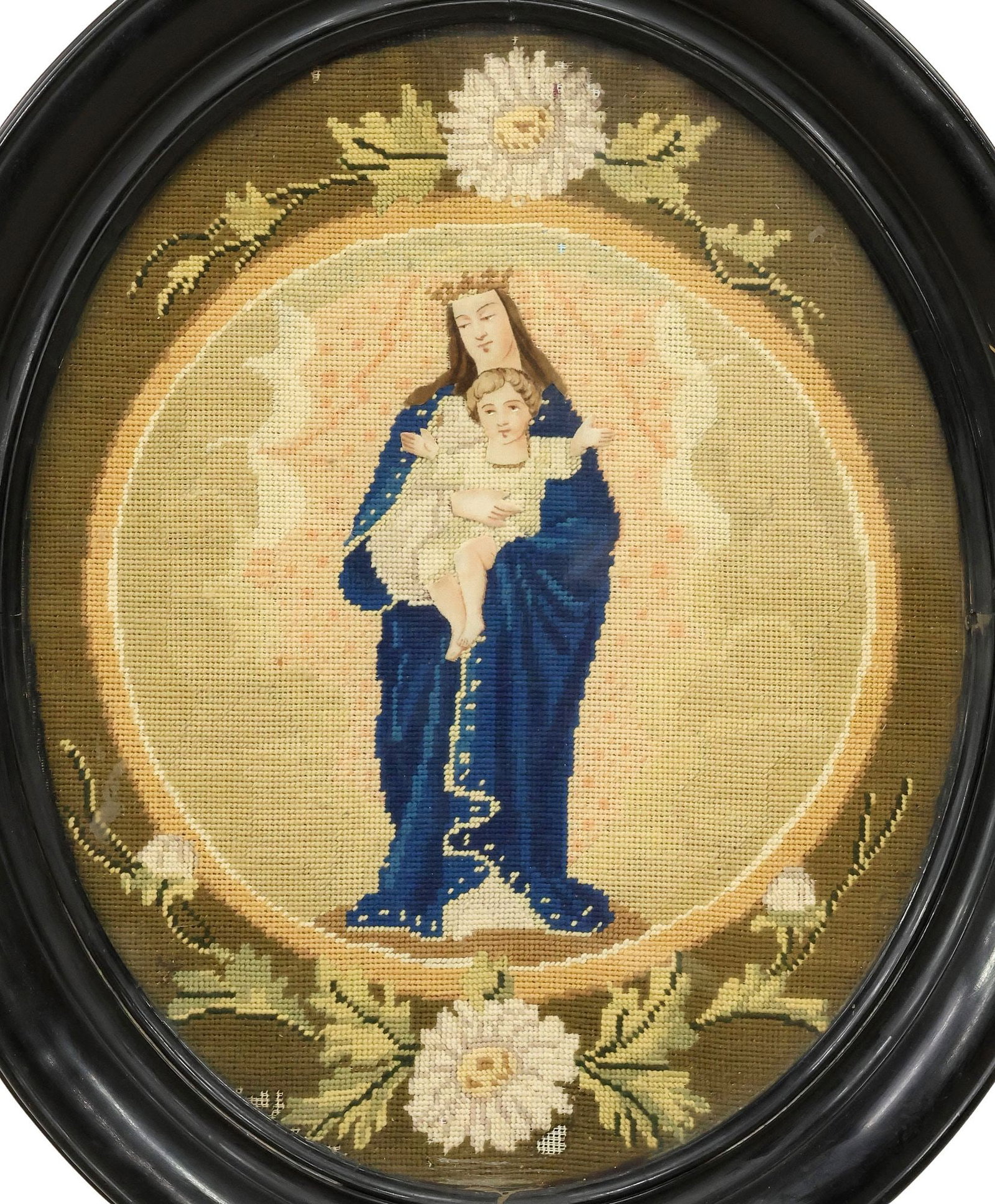 FRAMED RELIGIOUS NEEDLEPOINT EMBROIDERY PICTURE, MADONNA & CHILD: Framed needlepoint embroidery picture, Madonna and Child, with printed limbs and facial features, bordered by white daisies and foliate motifs, small areas of exposed canvas backing along lower edge, 