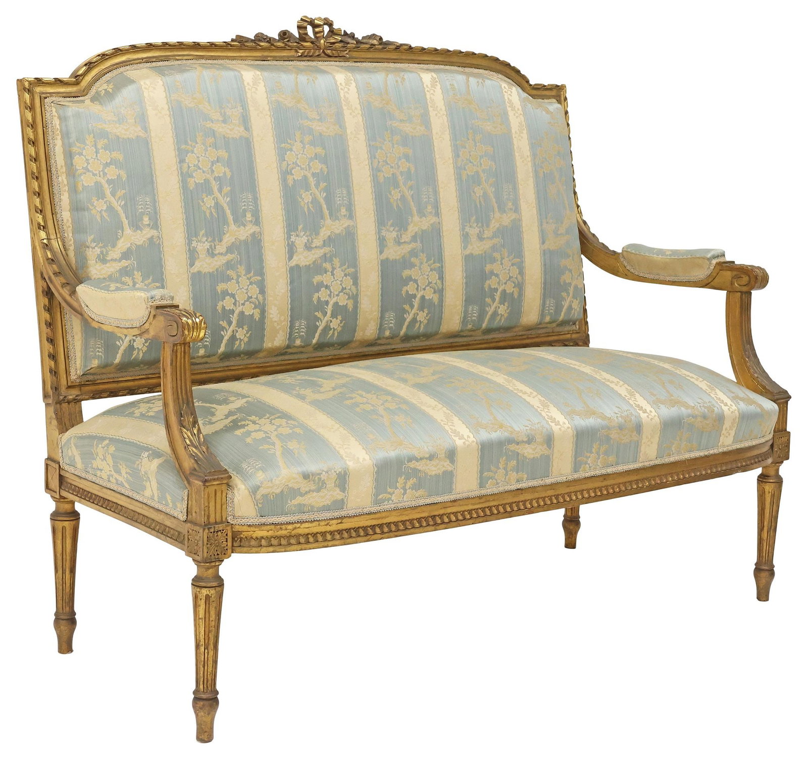 FRENCH LOUIS XVI STYLE SILK-UPHOLSTERED GILTWOOD SALON SETTEE: French Louis XVI style giltwood salon sofa, early 20th c., having ribbon twist trim and floral bow crest, padded back, arms, and seat in a silk jacquard upholstery, on tapering fluted legs, approx 43.