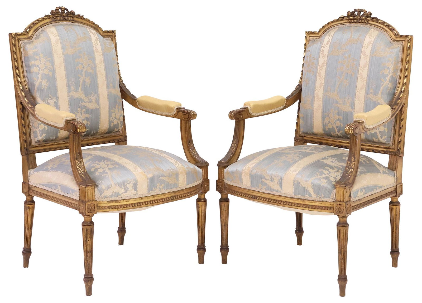 (2) FRENCH LOUIS XVI STYLE SILK-UPHOLSTERED GILTWOOD ARMCHAIRS: (pair) French Louis XVI style giltwood armchairs/ fauteuils, early 20th c., having ribbon twist trim and floral bow crest, padded back and seat in a striped silk jacquard upholstery, padded arms in a 