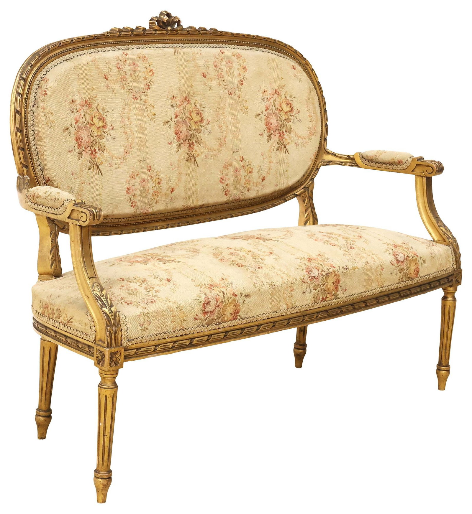 FRENCH LOUIS XVI STYLE UPHOLSTERED GILTWOOD SALON SETTEE: French Louis XVI style giltwood salon settee, late 19th c., having oval medallion back and padded seat, in floral-patterned upholstery, rising on tapering fluted legs, approx 38.5"h, 47.5"w, "d, seat 
