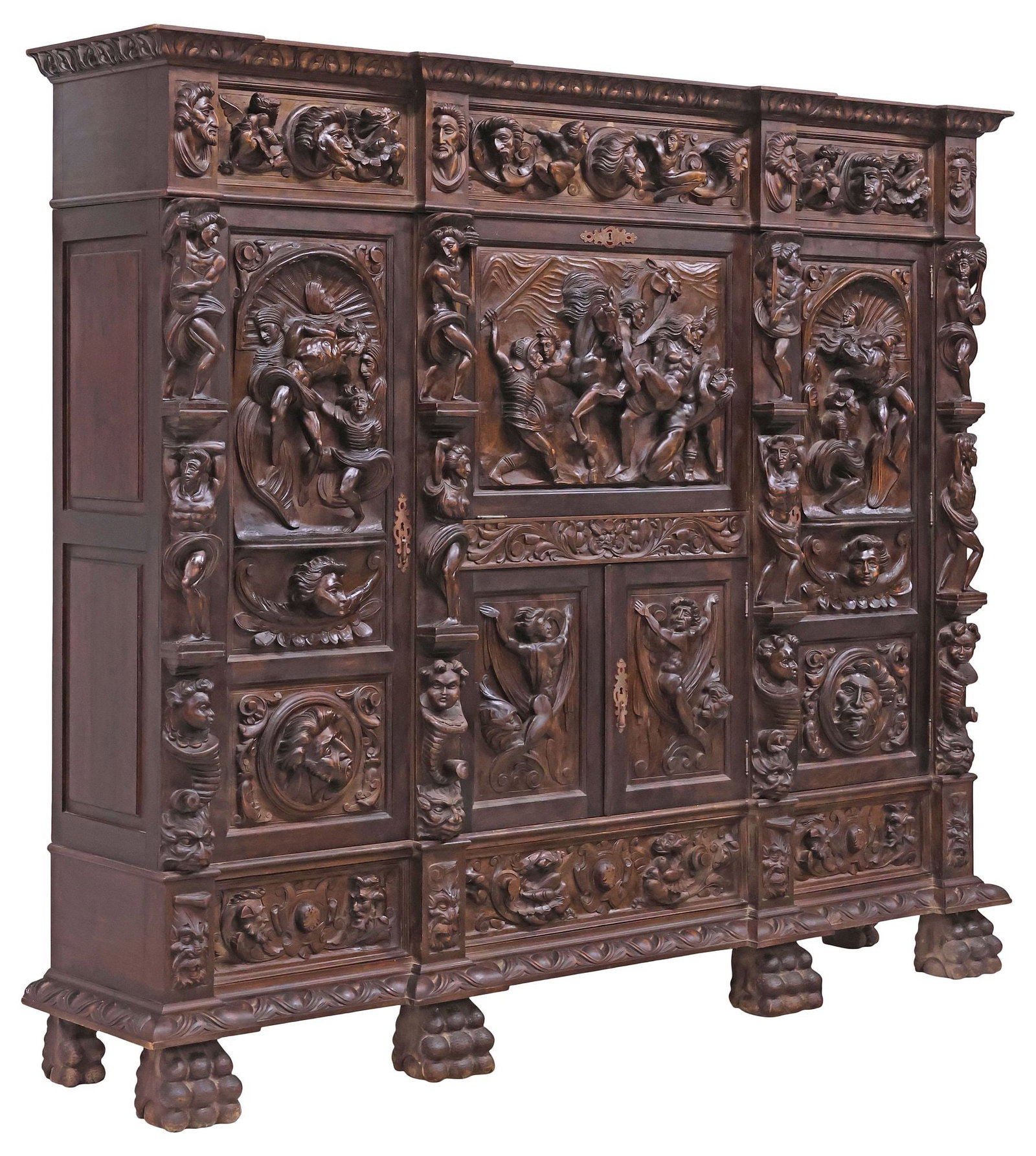 FINE SPANISH RENAISSANCE REVIVAL HIGHLY-CARVED WALNUT FIGURAL SECRETARY BOOKCASE: Spanish Renaissance Revival walnut secretary bookcase, late 19th c., foliate-molded cornice, over heavily carved case with religious figural scenes and portrait roundels in high relief, fitted with ce