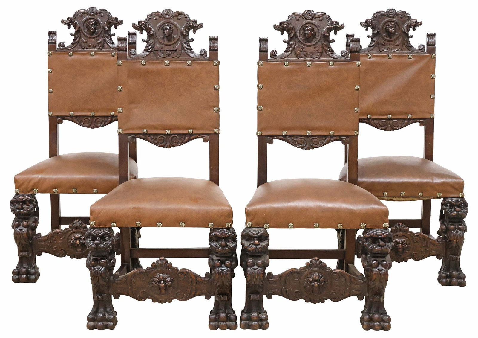 (4) SPANISH RENAISSANCE REVIVAL UPHOLSTERED CARVED OAK CHAIRS: (lot of 4) Spanish Renaissance Revival carved oak side chairs, 19th c., each having scrolled crest with central portrait plaque, flanked by fluted finials, padded back and seat in later faux leather u
