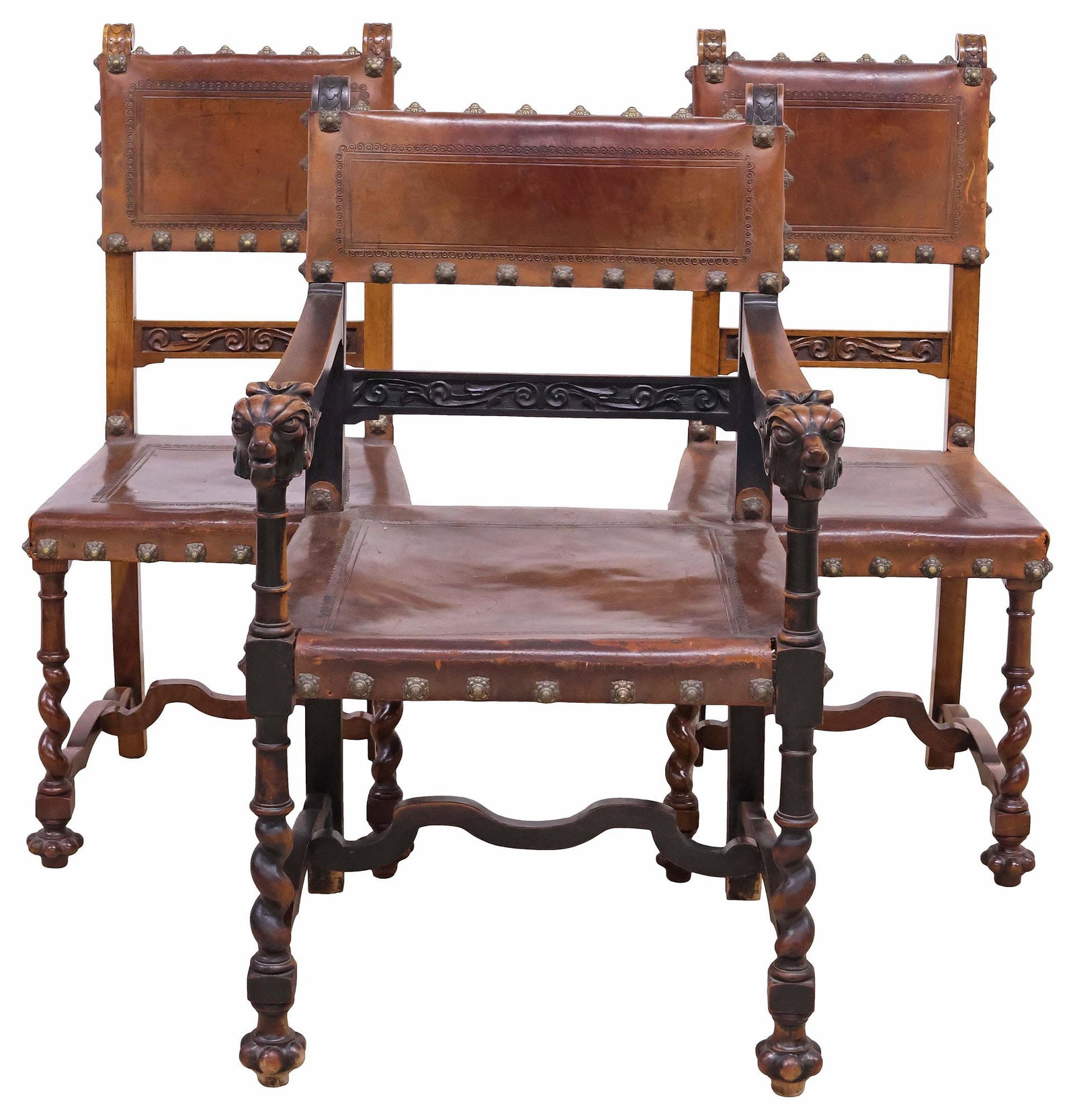 (3) SPANISH RENAISSANCE REVIVAL LEATHER-UPHOLSTERED WALNUT CHAIRS: (lot of 3) Spanish Renaissance Revival walnut seating group, 19th c., each in worn tooled leather upholstery, finished with large nailheads, rising on spiral-turned legs and bulbous gadrooned feet, jo