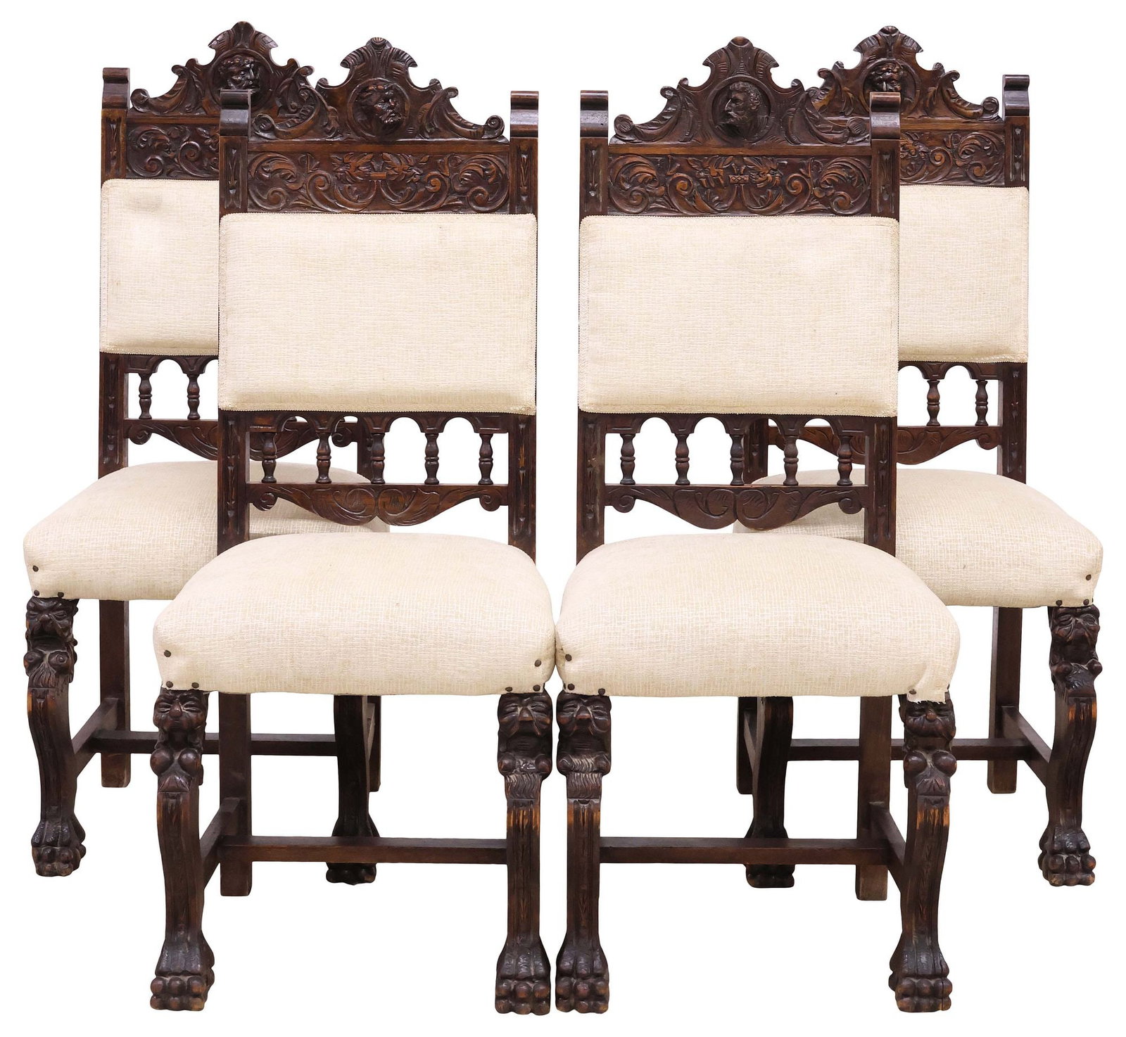 (4) SPANISH RENAISSANCE REVIVAL UPHOLSTERED OAK CHAIRS: (lot of 4) Spanish Renaissance Revival carved oak side chairs, 19th c., each having scrolled crest with protruding portrait plaque, above spindled back, in later beige fabric upholstery, with ribbon t