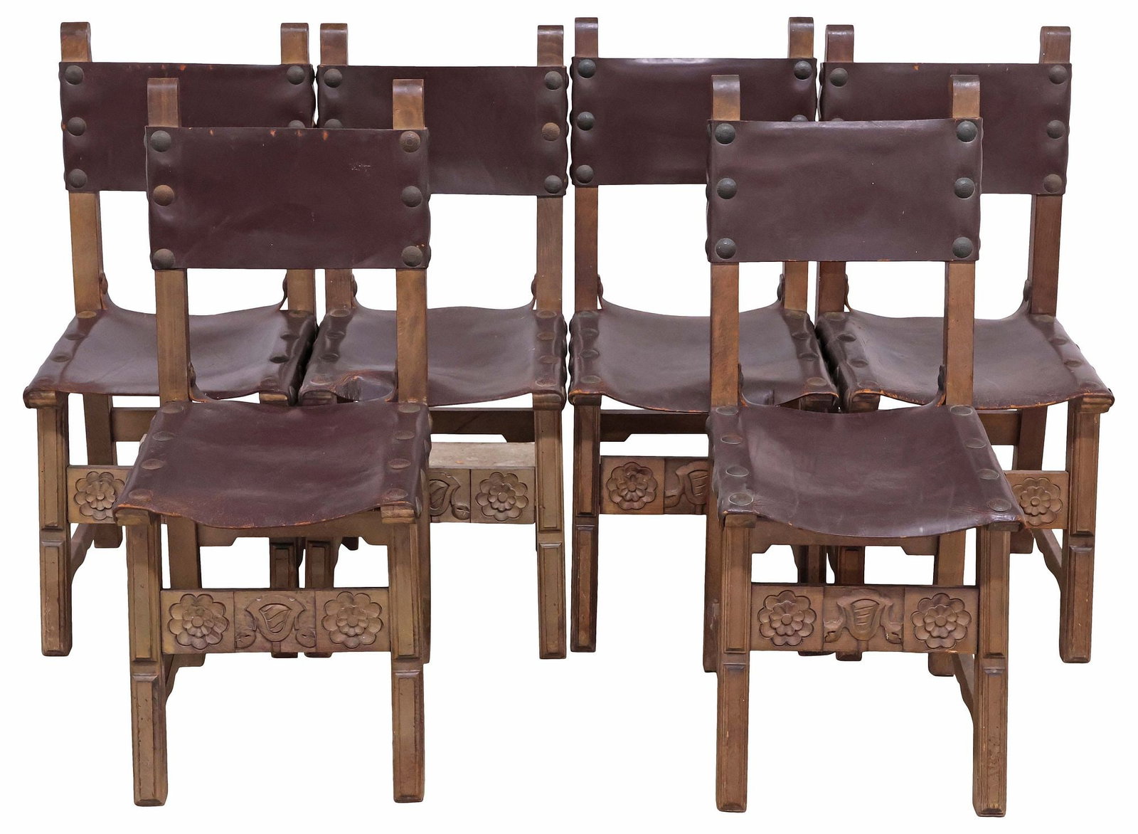 (6) SPANISH BAROQUE FLORAL CARVED WALNUT SIDE CHAIRS: (lot of 6) Spanish Baroque style walnut side chairs, late 19th c., each having leather back and seat, with oversized nailhead trim, over floral carved front stretcher, approx 36"h, 16"w, 19"d, seat he