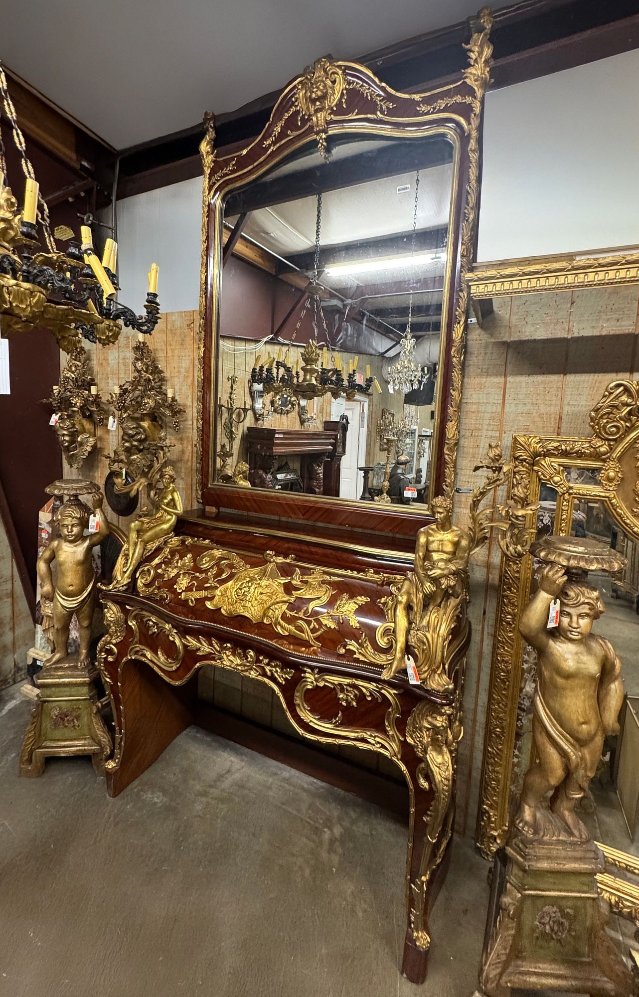 LARGE LOUIS XV STYLE ORMOLU-MOUNTED MIRROR & FIREPLACE SURROUND: Louis XV style mirror and fireplace surround/ chimneypiece, each with bronze dore mounts, comprising mirror with shaped frame, encasing flat mirror plate, above fireplace mantel with central shield-fo