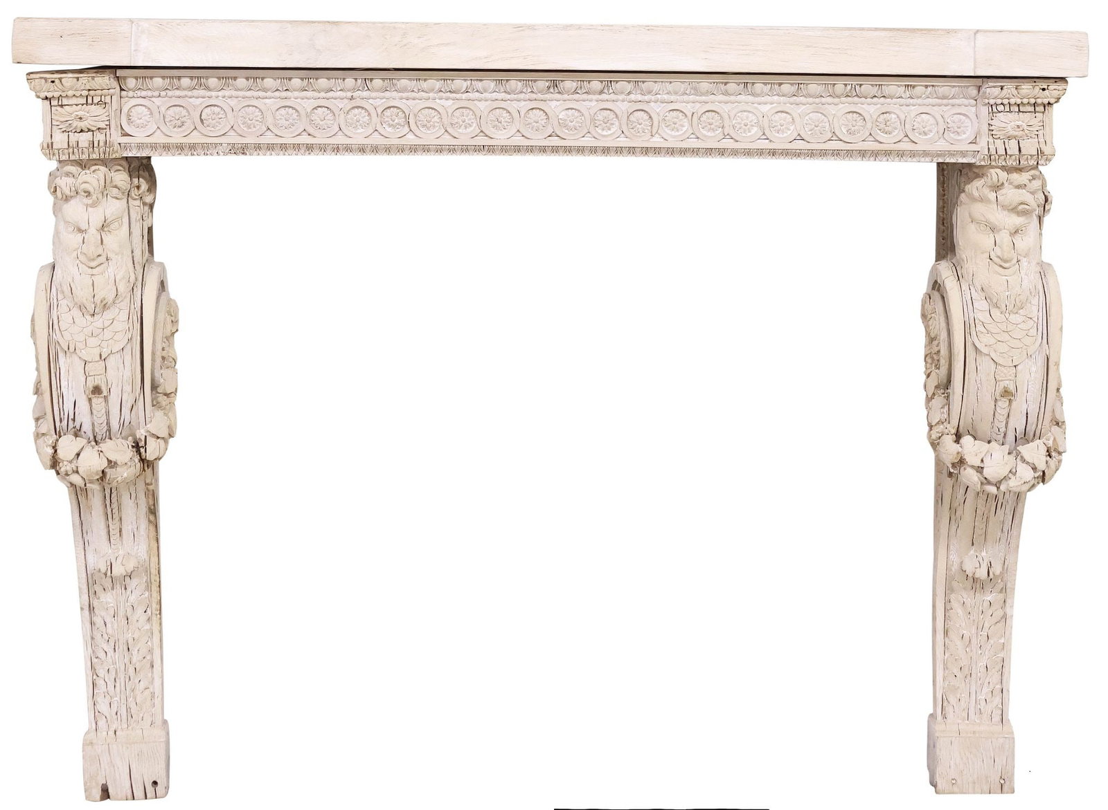 RUSTIC RENAISSANCE REVIVAL ARCHITECTURAL CARVED FIREPLACE SURROUND: Renaissance Revival stripped oak fireplace surround, 19th, fashioned from antique and later elements, remnants of a white-washed finish, rectangular mantle, over molded frieze with floral lunettes, an