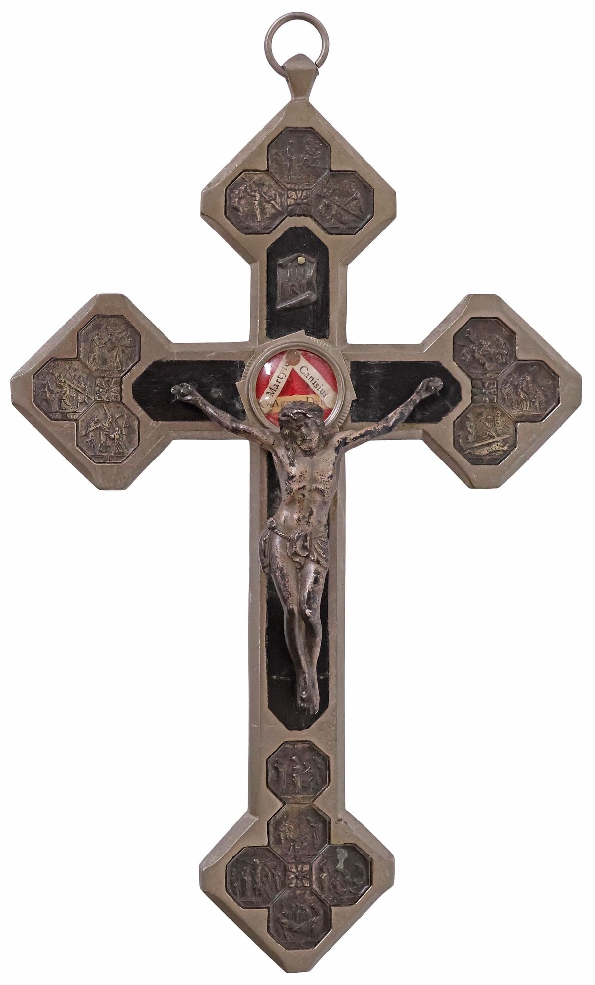 LARGE RELIQUARY CRUCIFIX WITH EMBOSSED 14 STATIONS, RELICS OF 3 MARTYR SAINTS: Large silver-tone metal and ebony-inlaid reliquary crucifix, early 20th c., central sealed theca housing relics of (three) martyred saints, comprising Saints Peter Canisius, Laurentius (Lawrence or La