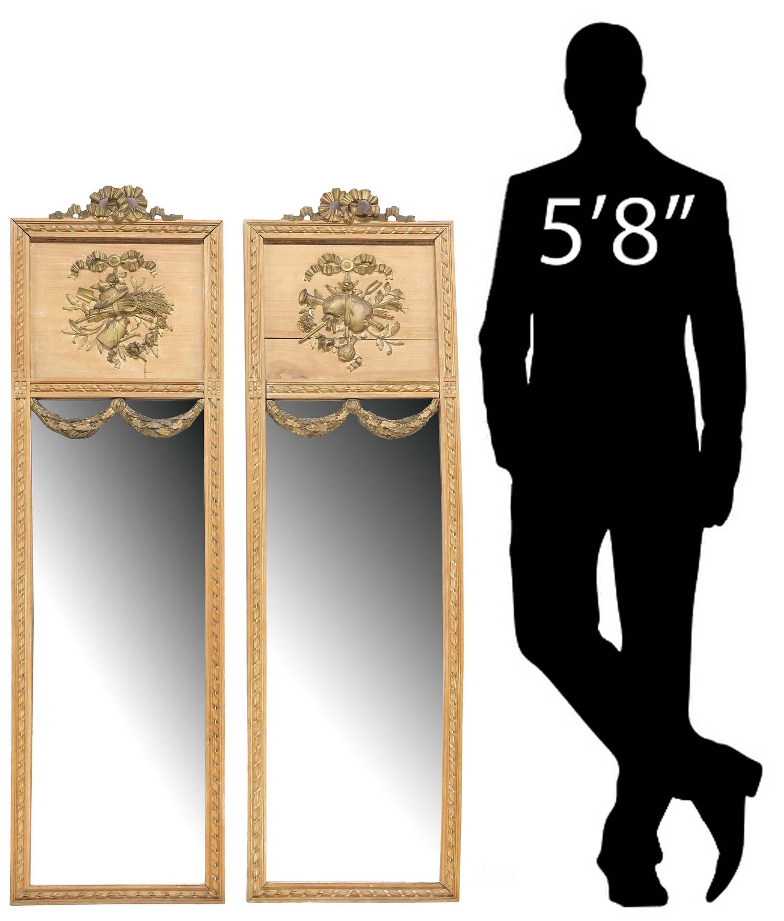 (2) LOUIS XVI STYLE PARCEL-GILT STRIPPED OAK PIER MIRRORS: (pair) Louis XVI style stripped oak pier mirrors, early 20th c., each with molded giltwood bow crest, above musical trophies or harvest motifs, ribbon twist trim, encasing flat mirror plates, overlaid