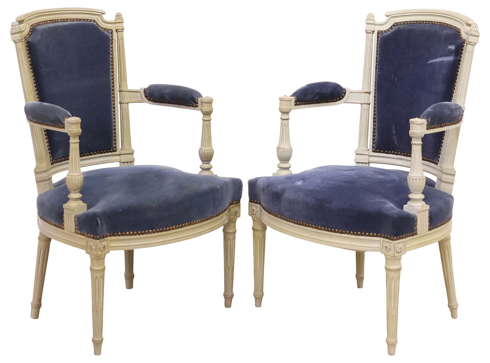 (2) FRENCH LOUIS XVI STYLE PAINTED & UPHOLSTERED ARMCHAIRS / FAUTEUILS: (pair) French Louis XVI style white-painted armchairs/ fauteuils, early 20th c., each in blue fabric upholstery, with nailhead trim, on tapering fluted supports, ending on arrow feet, approx 34.5"h, 2
