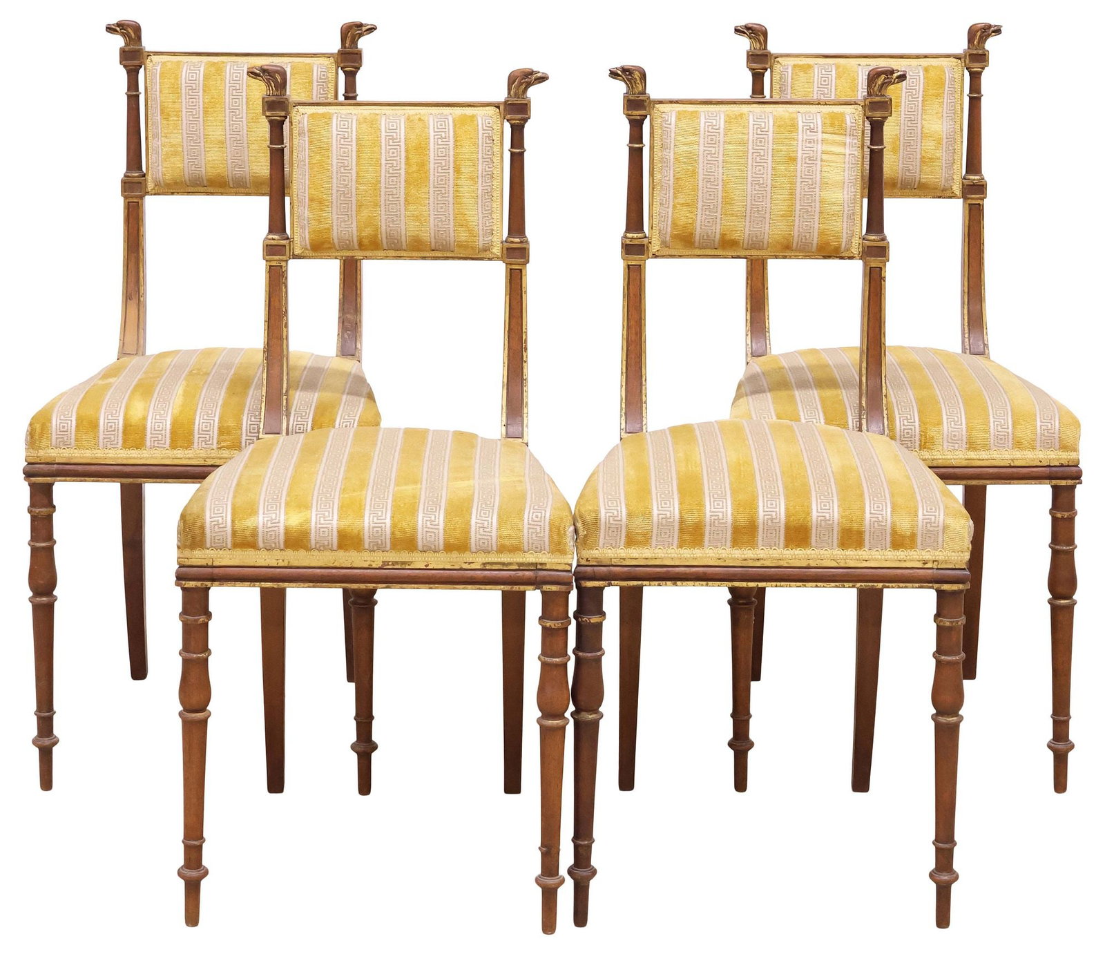 (4) REGENCY STYLE CARVED EAGLE HEAD & PARCEL-GILT WALNUT DINING CHAIRS: (lot of 4) Regency style parcel-gilt carved walnut dining chairs, early 20th c., each having padded back and seat in striped fabric upholstery, eagle head finials, on tapering turned supports, approx 
