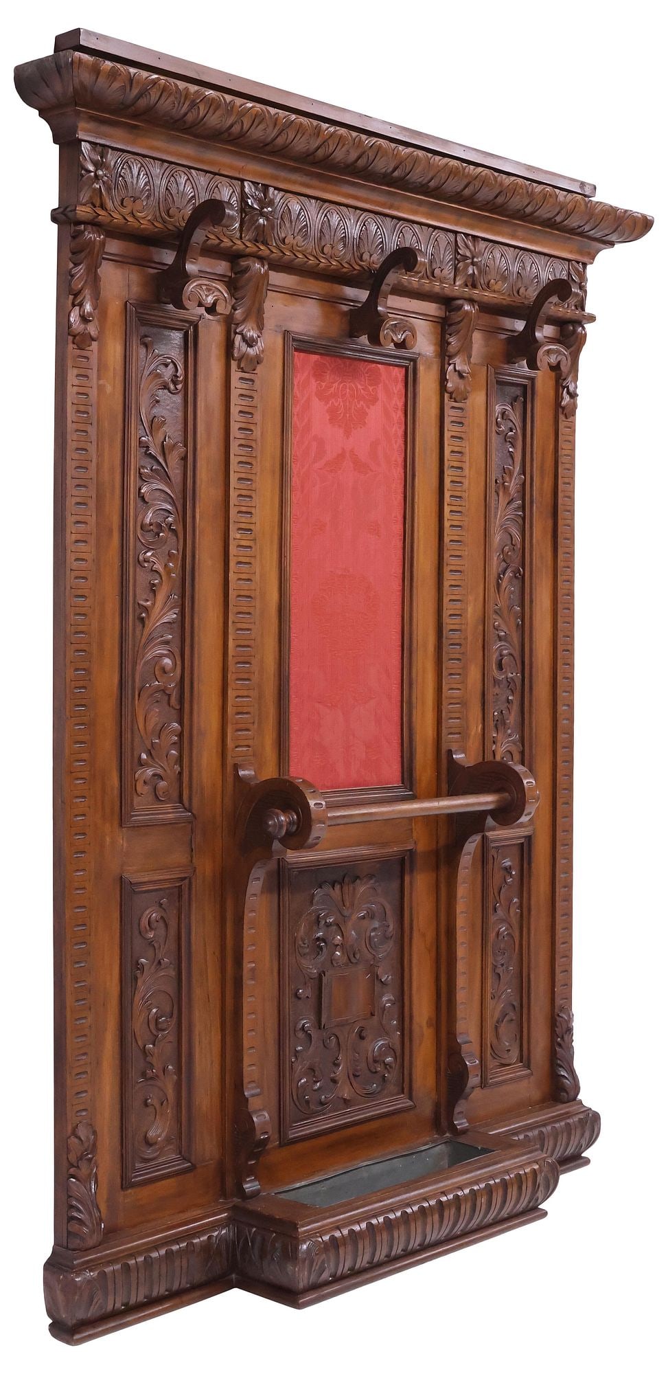 ITALIAN RENAISSANCE REVIVAL CARVED WALNUT HALL TREE: Italian Renaissance Revival walnut hall tree, early 20th c., having molded cornice, above carved frieze with palm fronds, paneled back with foliated scrollwork and central upholstery in a red jacquard