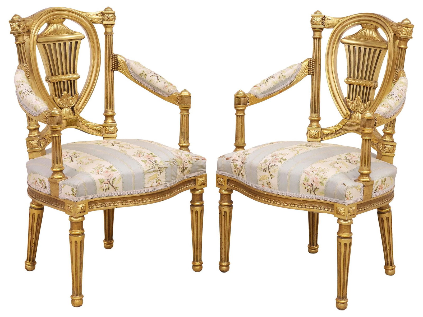 (2) FRENCH LOUIS XVI STYLE UPHOLSTERED GILTWOOD LYRE-BACK ARMCHAIRS: (pair) French Louis XVI style armchairs/ fauteuils, early 20th c., each having giltwood openwork splat with central lyre motif, padded arms and seat in worn floral patterned upholstery, on tapering fl