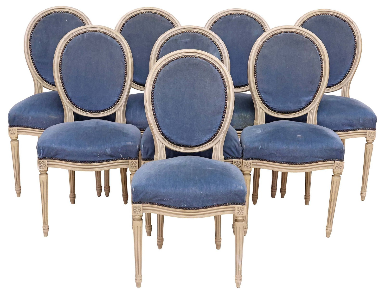 (8) FRENCH LOUIS XVI STYLE PAINTED & UPHOLSTERED DINING CHAIRS: (lot of 8) French Louis XVI style white-painted side chairs, early 20th c., oval medallion back and padded seat in blue fabric upholstery, with nailhead trim, on tapering fluted supports and toupie fe