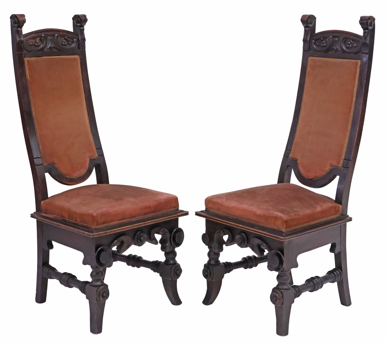 (2) SPANISH MODERNISME / ART NOUVEAU CARVED WALNUT HIGH-BACK CHAIRS: (pair) Spanish Art Nouveau Modernisme/ Art Nouveau walnut high-back chairs, early 20th c., having raised foliate stiles, padded back and seat in a worn upholstery with applique trim, carved apron with