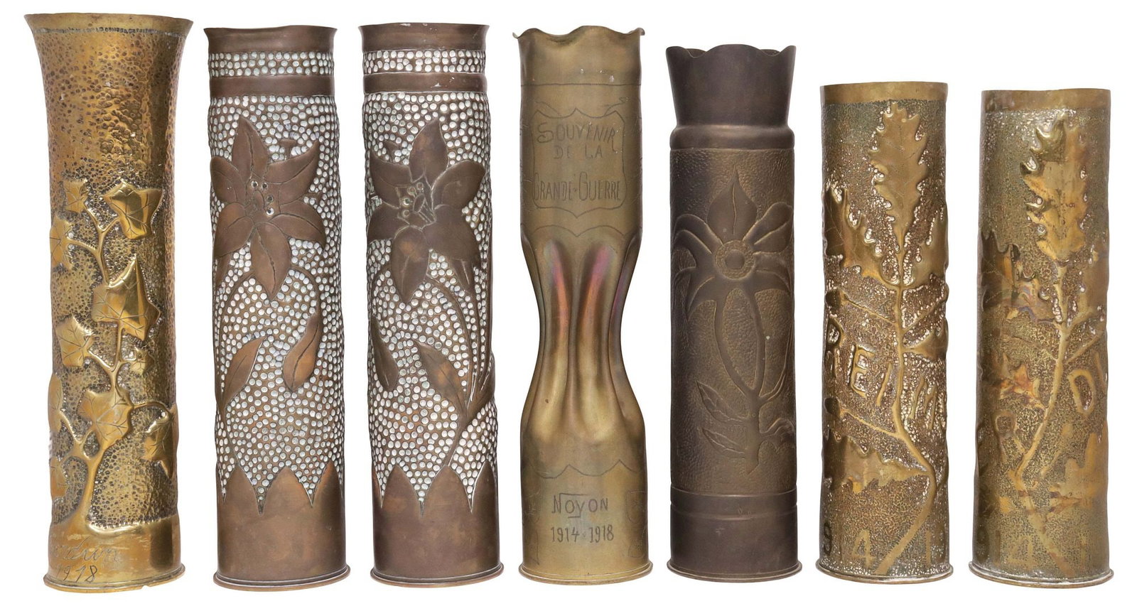 (7) FRENCH WWI-ERA TRENCH ART ARTILLERY SHELL VASES: (lot of 7) French WWI-era trench art vases, fashioned from artillery shells, including: (pair) with lilies on dotted ground, (pair) having repousse foliates above dated inscription "1914-1918," marked