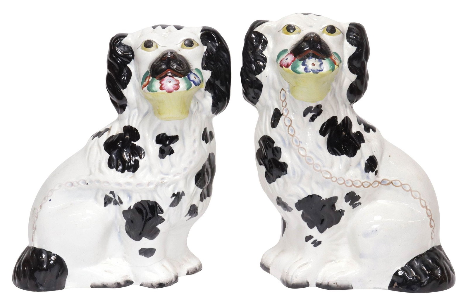 (2) ENGLISH VICTORIAN STAFFORDSHIRE DISRAELI MANTEL DOGS WITH BASKETS: (pair) English Victorian Staffordshire mantel dogs, 19th c., modeled as seated Disraeli spaniels holding a flower basket, with painted features, each with stable hairlines, one at back and one at foot