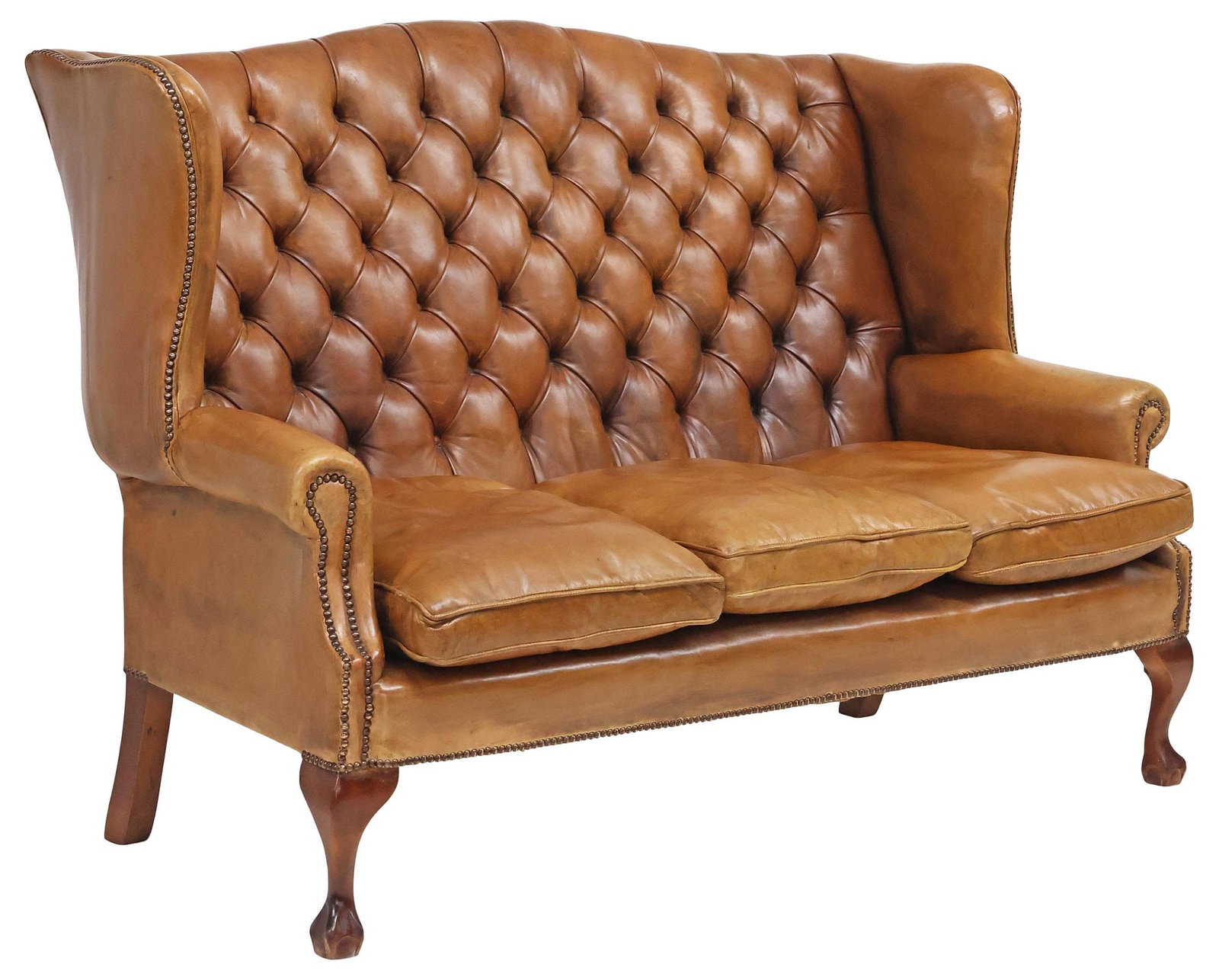 ENGLISH CHIPPENDALE STYLE TAN LEATHER WINGBACK SOFA: English Chippendale style wingback sofa, 20th c., in button-tufted tan leather upholstery, with nailhead trim, three removable seat cushions, rising on cabriole legs, over claw-and-ball feet, approx