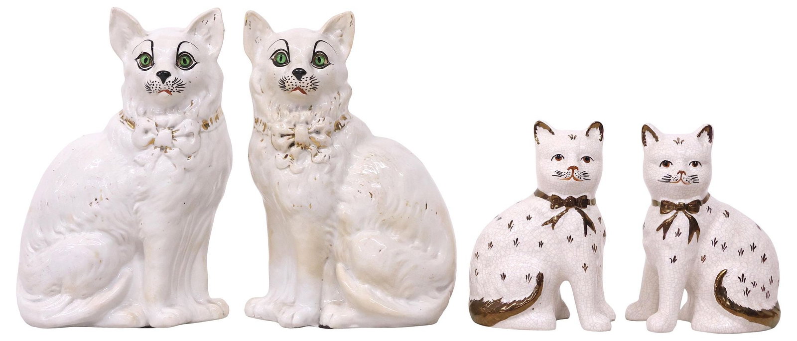 (4) ENGLISH STAFFORDSHIRE MANTEL CATS: (pair) English Staffordshire mantle figures, early 20th c., comprising two pairs, each modeled as a seated cat, with painted features, including: (2) with green inset glass eyes, and remnants of parce