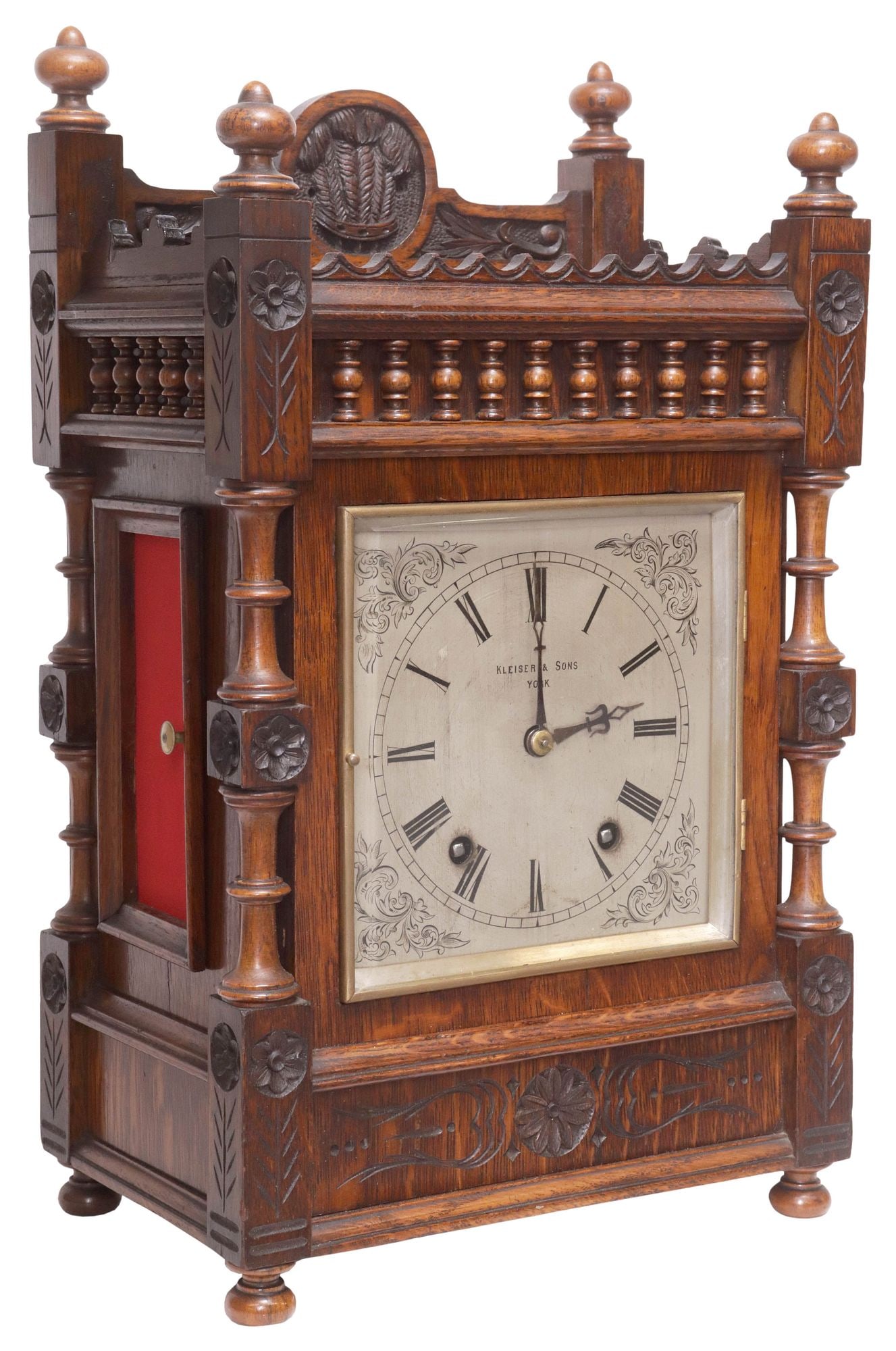 ENGLISH VICTORIAN KLEISER & SONS CARVED OAK MANTEL SHELF CLOCK: English Victorian carved oak mantel clock, Kleiser and Sons, York, early 20th c., spindled rectangular case with turned finials and raised gallery, central roundel with sheath of wheat motif, brushed 