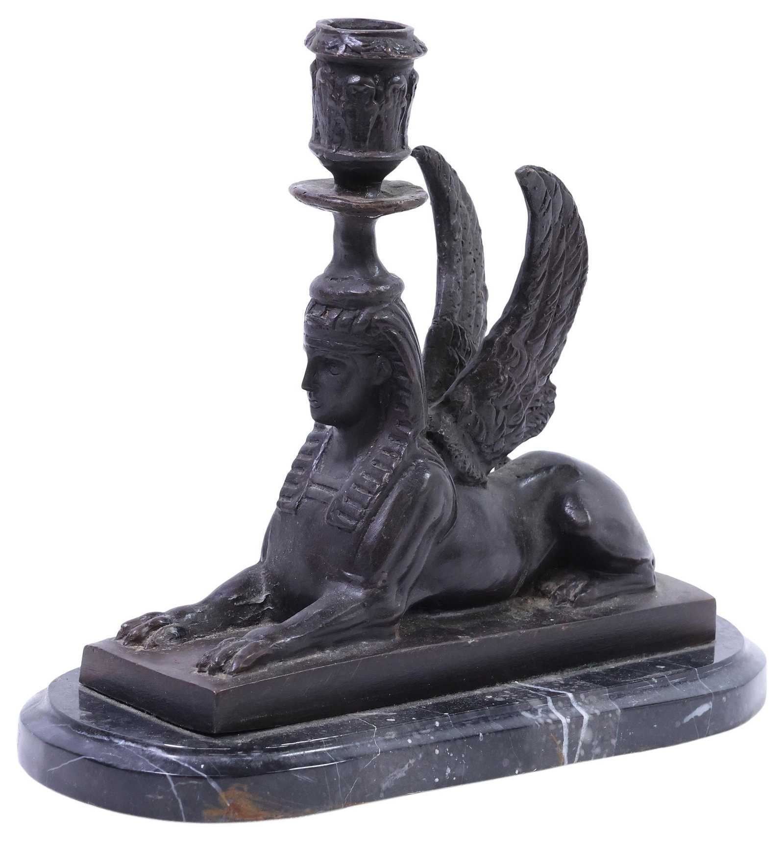 EGYPTIAN REVIVAL PATINATED BRONZE SPHINX CANDLESTICK ON MARBLE BASE: Egyptian Revival patinated bronze sculptural candlestick, early 20th c., modeled as a seated sphinx, on integral black marble base, overall: approx 8.75"h, 9.75"w, 4.25"d, 6.25lbs