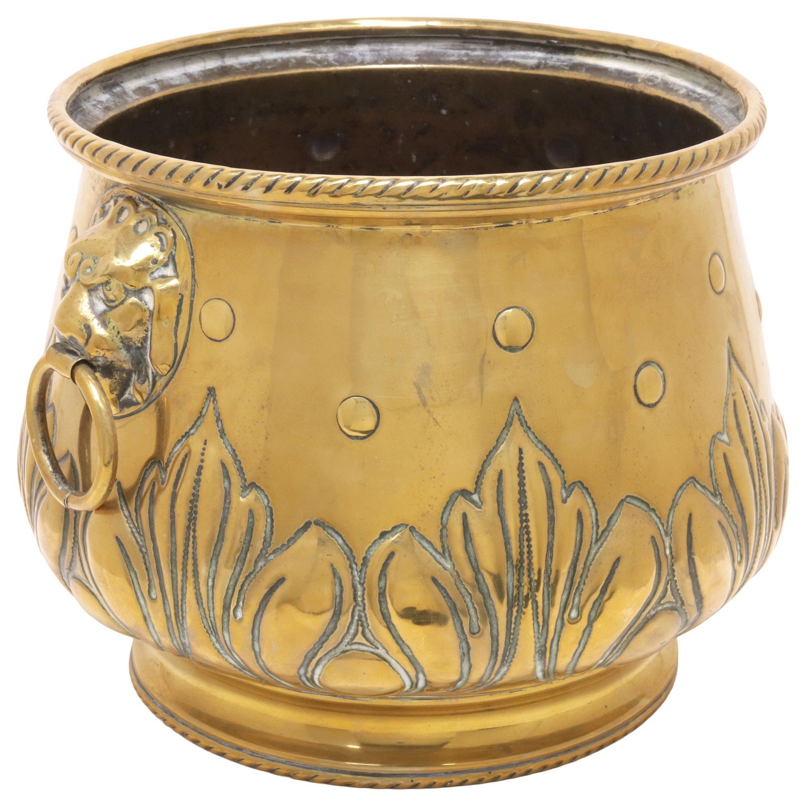 ENGLISH EDWARDIAN BRASS REPOUSSE LION MASK PLANTER / JARDINIERE: English Edwardian brass planter/ jardiniere, early 20th c., having ribbon twist border, above dual lion mask handles with captured rings, repousse foliate motifs, approx 9.5"h, 11.75"w, 11.5"d,