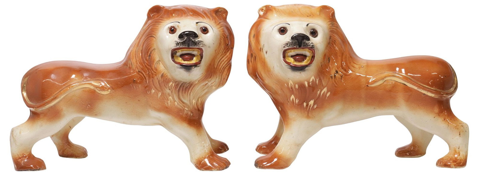 (2) SCOTTISH BO'NESS POTTERY MANTEL FIGURES, STANDING LIONS: (pair) Scottish Bo'ness pottery mantle figures, late 19th c., modeled as standing lions, with inset glass eyes, in a white and orange finish with parcel-gilt accents, approx 10"h, 13.5"w, 6.5"d,