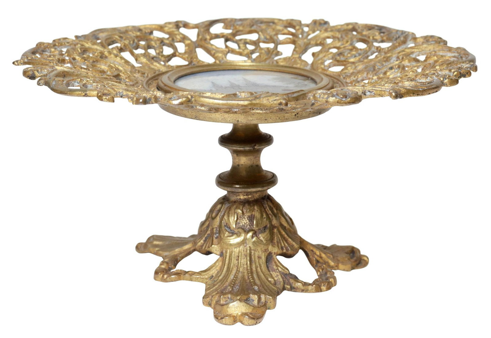 ENGLISH GILT-BRASS & REVERSE-PAINTED GLASS TAZZA: English gilt-brass and glass tazza, early 20th c., openwork scrolling foliate border, centering reverse-painted glass roundel, depicting the Palace of Westminster, on tripartite stand, approx 3.5"h, 7
