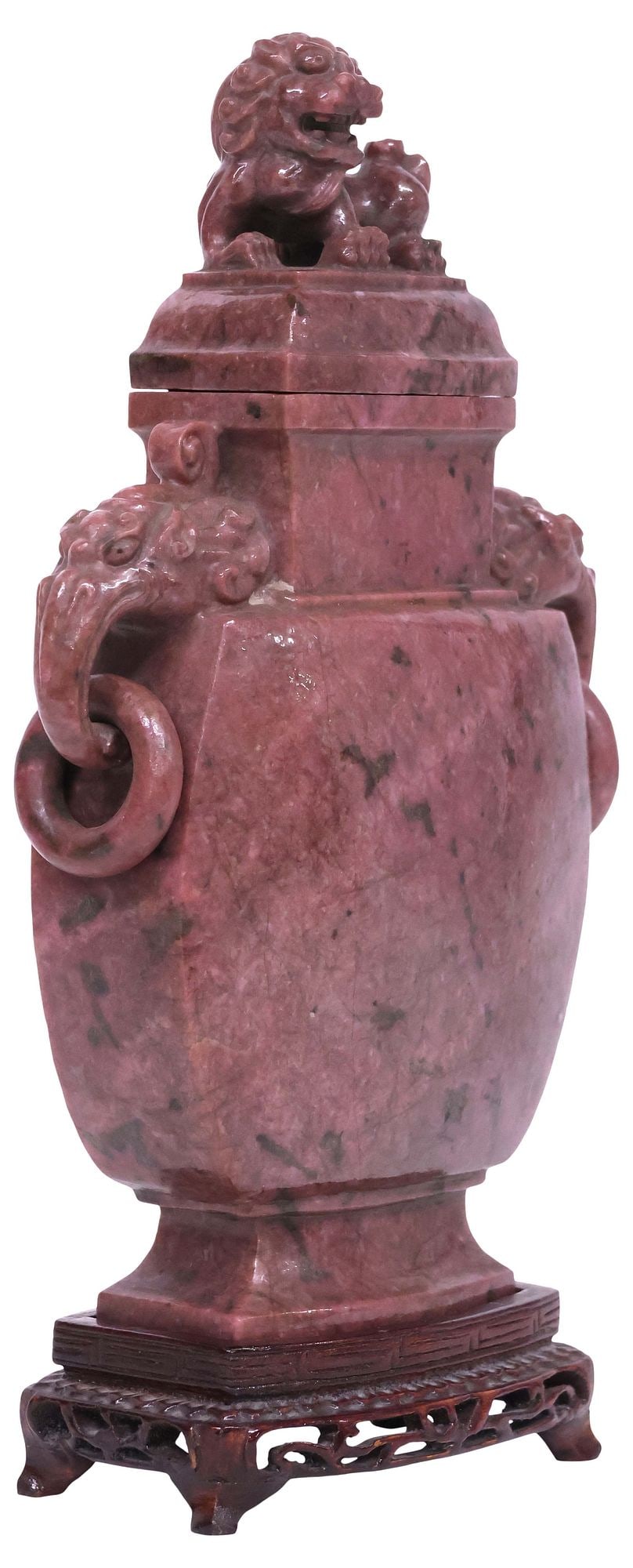CHINESE CARVED PINK HARDSTONE FOO LION COVERED VASE ON WOOD BASE: Chinese carved pink hardstone covered vase, having lid with foo lion finial, dual handles with elephant masks and rings, over tapered body, rising on wood base, vase: approx 9.75"h, 6.25"w, 2.5"d, ove