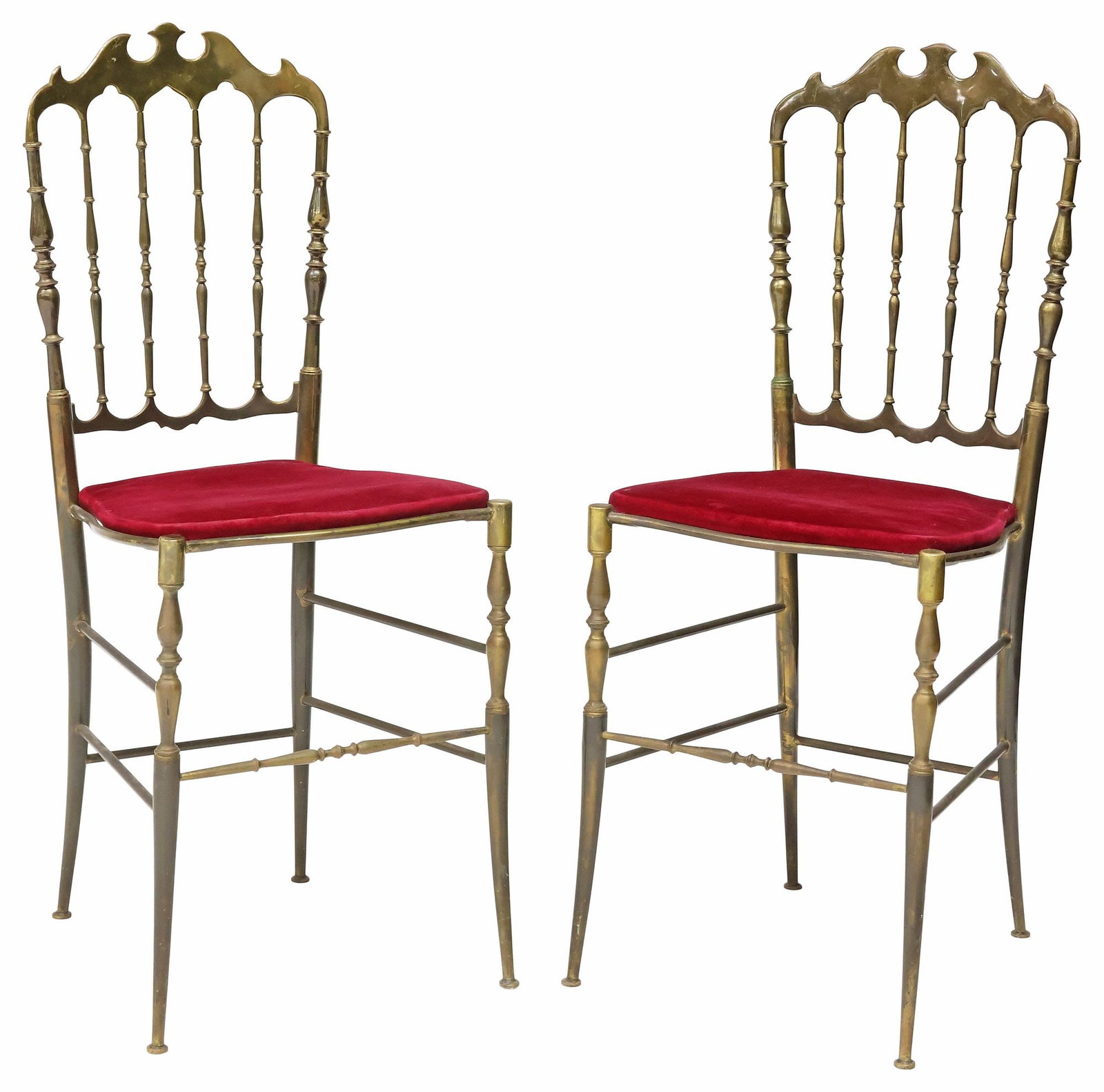 (2) ITALIAN CHIAVARI STYLE UPHOLSTERED BRASS CHAIRS: (pair) Italian Chiavari style brass chairs, 20th c., each with spindled back, and shaped seat in a red velvet upholstery, on stretcher-joined tapered legs, approx 36.25"h, 15"w, 15.5"d, seat height: a