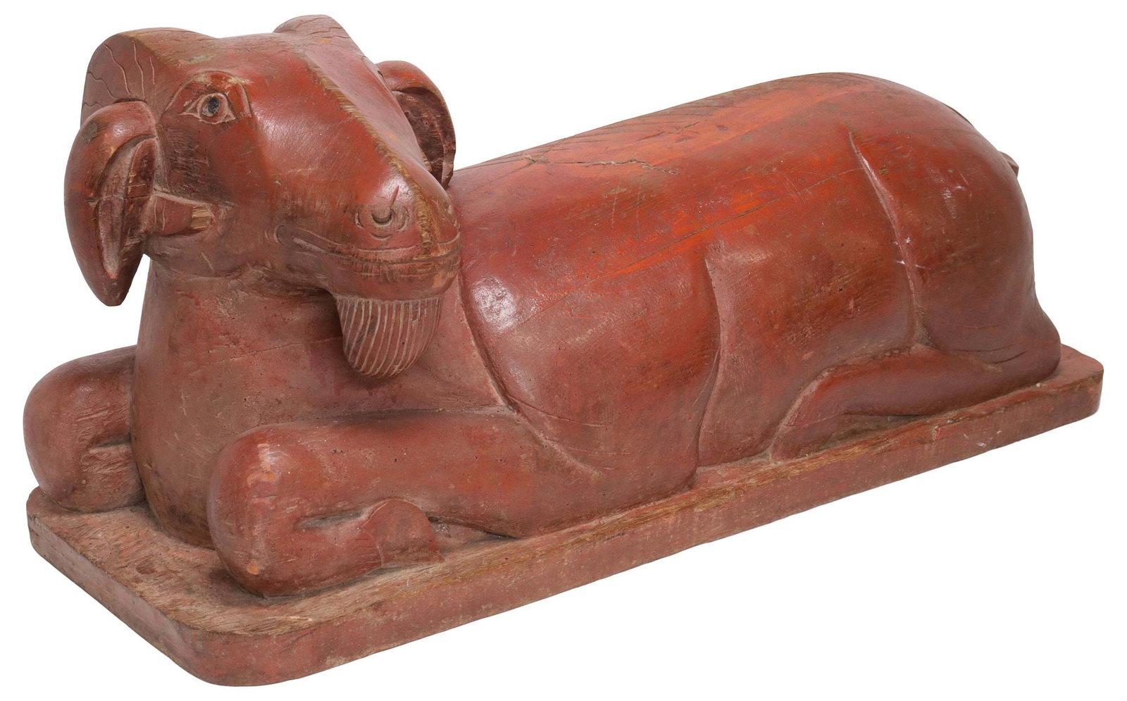 CARVED WOOD BEARDED SEATED RAM SCULPTURE: Well carved wood seated bearded ram sculpture finished in faded red paint, for shipping approx. 12"h, 29.5"w, 10"d, 50.5lbs