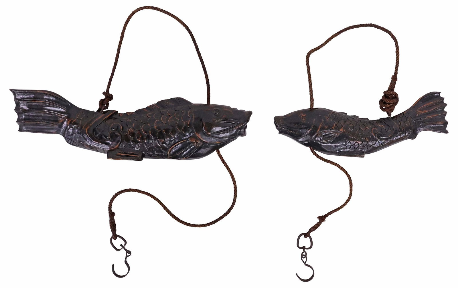 (2) JAPANESE CARVED HARDWOOD CARP-FORM JIZAI KAGI HEARTH HOOKS: (lot of 2) Japanese Jizai Kagi/ Irori carved hardwood hearth hooks, each modeled as a carp with fin-form feet, strung with rope cord and iron hook, varied sizes, largest: approx 7"h, 24"w, 4"d,
