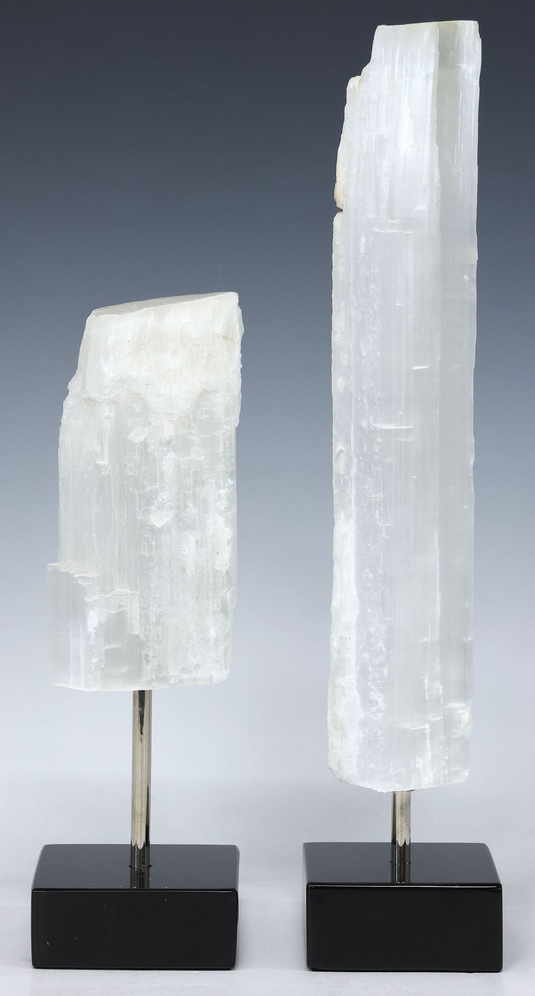 (2) GEOLOGICAL MOROCCAN SELENITE SPECIMENS ON MARBLE BASES: (lot of 2) Geological Moroccan selenite specimens, each on black marble base, largest specimen: approx 12"h, 2 3/8"w, 2.5"d, overall: approx 13.25"h, 3"w, 3"d, 7.25lbs total
