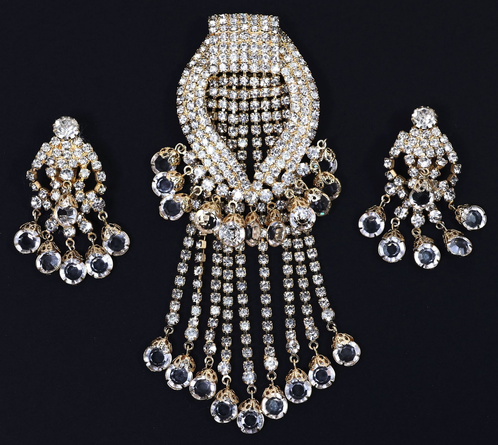 (2) VINTAGE HOBE RHINESTONE COSTUME JEWELRY, WATERFALL EARRINGS & BROOCH: (lot of 3) Estate vintage gold-tone metal and rhinestone costume jewelry set, Hobe, comprising: (1) brooch, tapering frame issuing nine rhinestone-embellished tassels, among numerous faceted drops, ma
