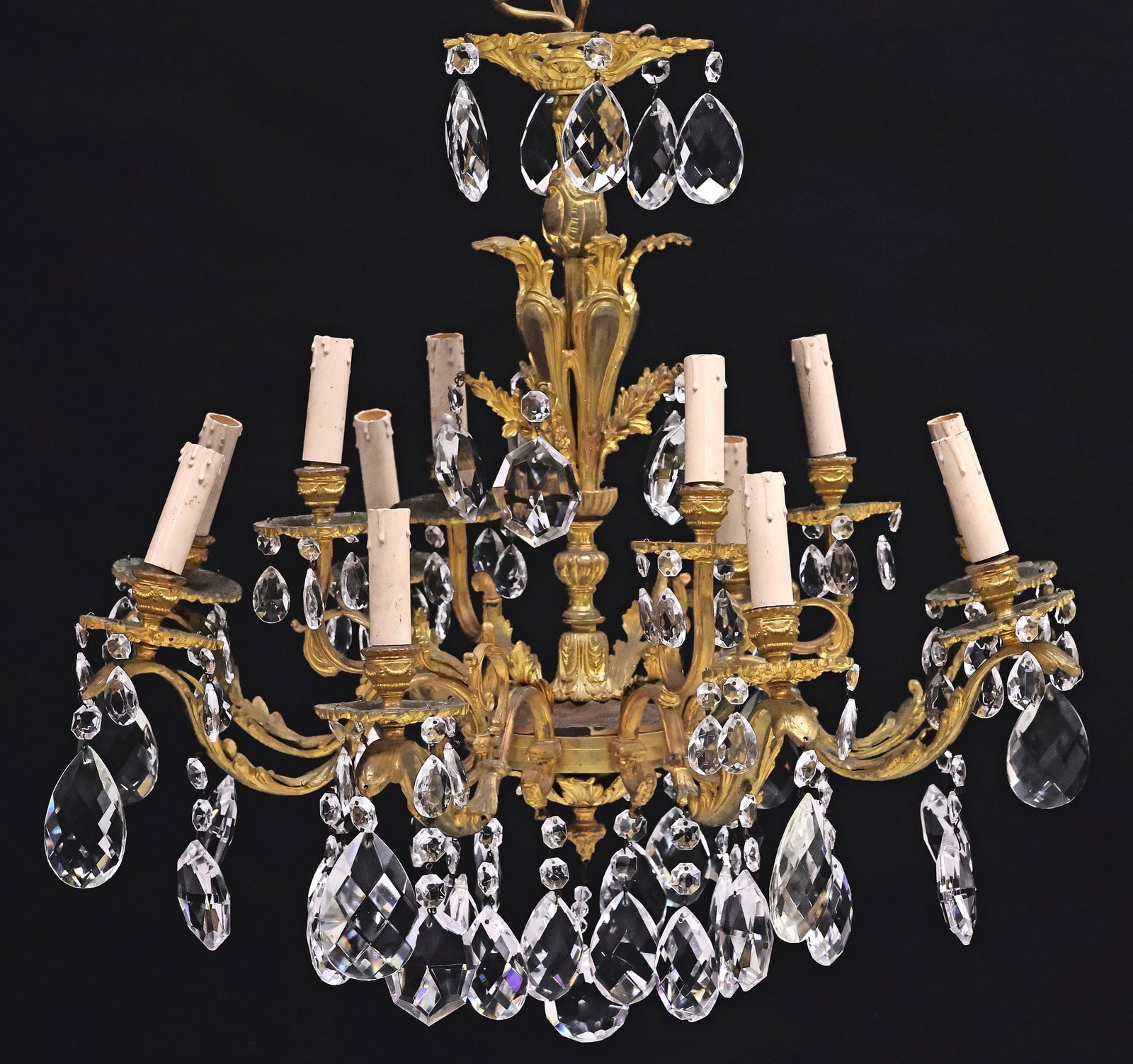 LOUIS XV STYLE GILT-METAL & CRYSTAL 12-LIGHT CHANDELIER: Louis XV style gilt-metal twelve-light chandelier, 20th c. foliated central standard issuing eight scrolled arms, hung with faceted crystal drops and beadwork, terminating at circular bobeche fitted w