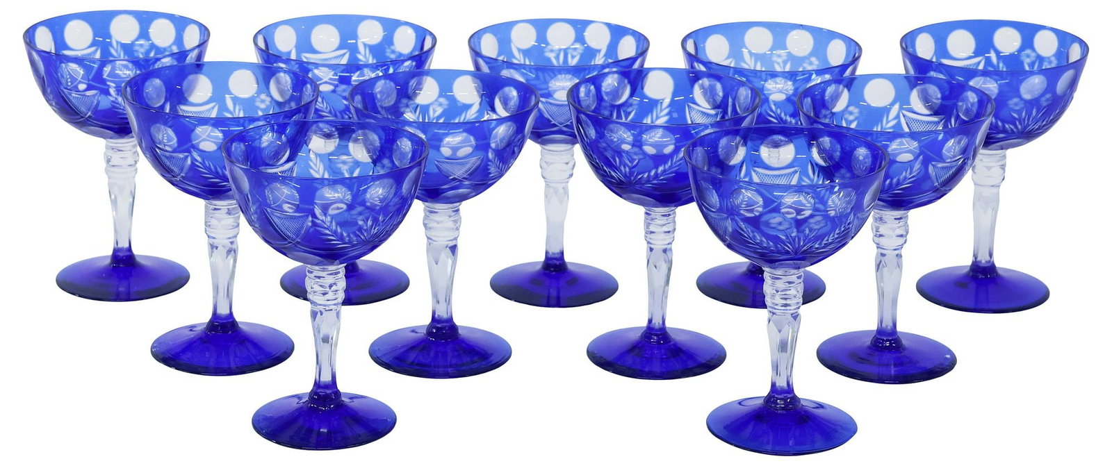 (11) COBALT BLUE CUT-TO-CLEAR CHAMPAGNE COUPES: (lot of 11) Cut-to-clear champagne coupes, each in cobalt blue, bowl with circular windows and foliate motifs, approx 5.5"h, 3.5"diam, 4lbs total **Provenance: The collection of retired United States 