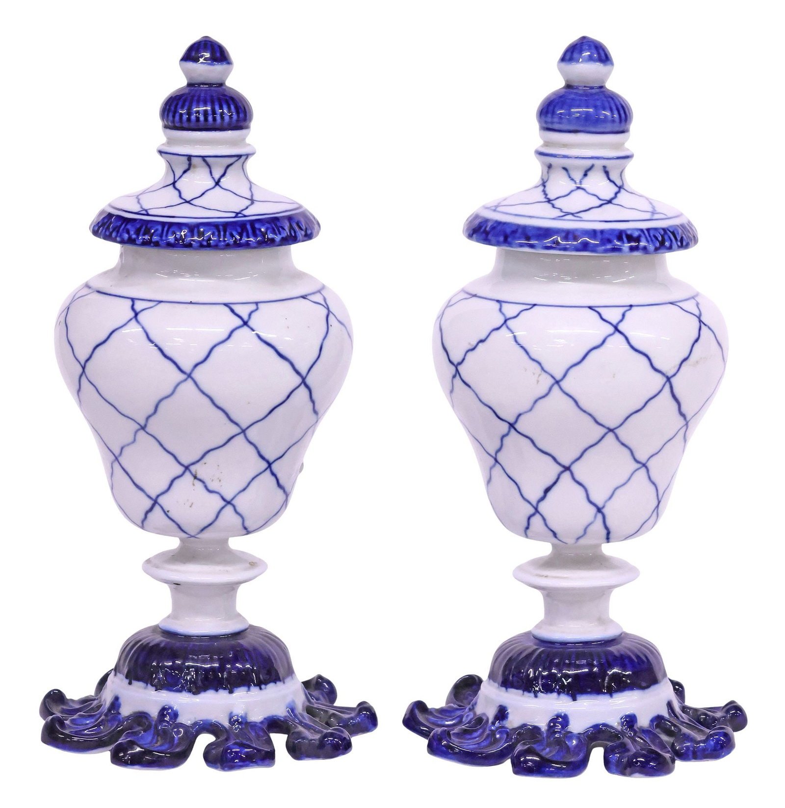 (2) SMALL FRENCH SEVRES STYLE BLUE & WHITE LATTICED URNS WITH COVERS, 9.25"H: French Sevres style blue and white porcelain urns and covers, 19th c., domed lids with turned-form finials, over tapered body with painted latticework, on integral socle base issuing cobalt scrolls, s