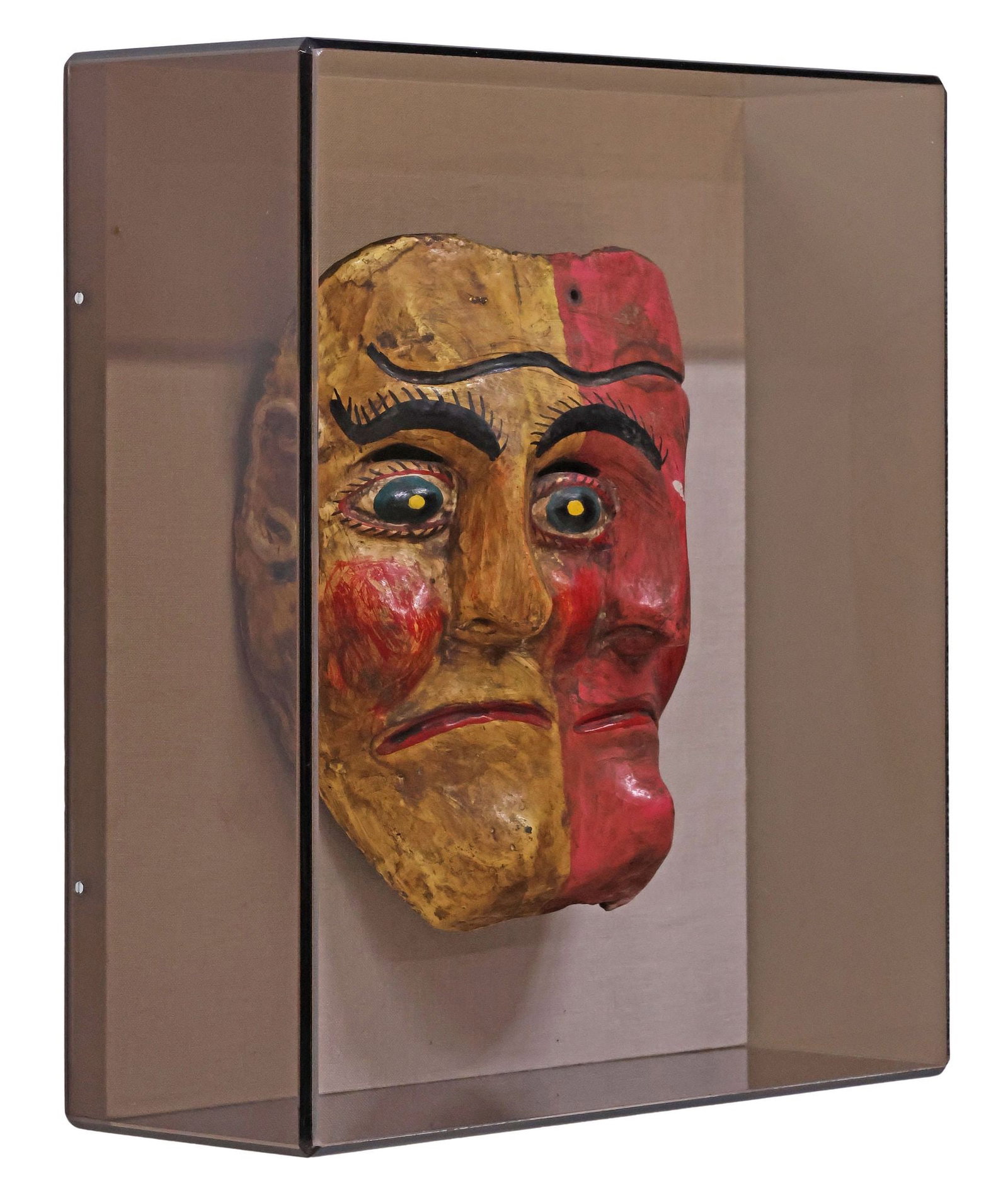 MEXICAN FOLK ART CARVED & PAINTED FIGURAL MASK IN ACRYLIC SHADOWBOX: Folk art carved and polychrome-painted dance mask, Mexico, mid 20th c., modeled as a figure of duality with two faces joined and sharing a central eye, housed in smoked acrylic shadowbox with